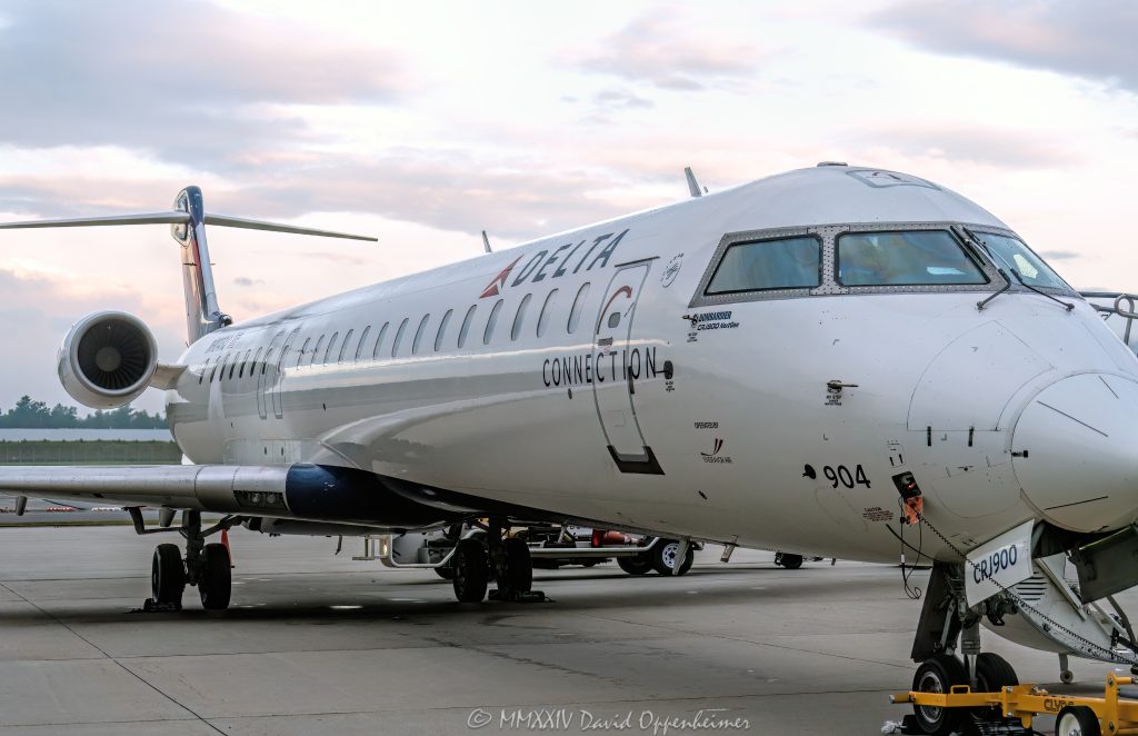 Bombardier CRJ900, Bombardier, CRJ900, Delta, Delta Air Lines, Delta Connection, commuter jet, commuter, airplane, plane, N904XJ, Asheville Regional Airport, AVL, KAVL, airport, Asheville Airport, Fletcher, aircraft, fly, flight, travel, air travel, Buncombe County, North Carolina, WNC, vacation, tourism, influx, visit, explore, regional jet, regional, sky, field, ready for takeoff, United States, horizontal, color, 1-13439195601,