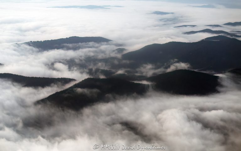 Cloud inversion in the Blue Ridge Mountains of Western North Carolina aerial view - © 2024 David Oppenheimer - Performance Impressions aerial photography archives - https://performanceimpressions.com Cloud inversion, Blue Ridge Mountains, Blue Ridge Parkway, clouds, cloud cover, cloud in mountains, mountains, ridgelines, ridges, Blue Ridge Parkway, foggy, weather, inversion, Western North Carolina, North Carolina, Asheville, WNC, NC, travel, morning, early, mountaintops, sea of clouds, Transylvania County, Buncombe County, Haywood County, Jackson County, thermal inversion, valleys, peaks, cold air, moisture, cloud formations, undulating, cloud photography, art, artwork, beauty, landscape, aerial photography, aerial, aerial photographer, David Oppenheimer, color, vertical, United States, home, color, horizontal, landscape, 1-13726821381,