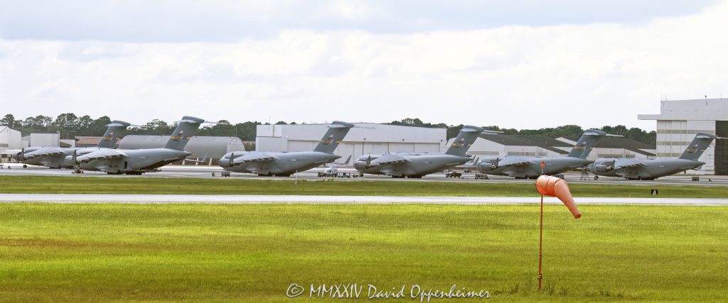Boeing C-17A Globemaster III jets at Joint Base Charleston - © 2024 David Oppenheimer - Performance Impressions photography archives - https://performanceimpressions.com Boeing C-17 Globemaster III, Boeing C-17, C-17s, Globemaster III, McDonnell Douglas, USAF, Charleston, Joint Base Charleston, Air Force, jets, transport, cargo, military, C-17A, airlift, Boeing, Charleston Air Force Base, base, airport, tarmac, IATA, ICAO, CHS, field, strategic, SAC, 315th Airlift Wing, windsock, wind sock, airport windsock, runway windsock, 437th Airlift Wing, aircraft, planes, Charleston, North Charleston, airport, South Carolina, David Oppenheimer, David Gordon Oppenheimer, United States, color, horizontal, 1-13726821381,