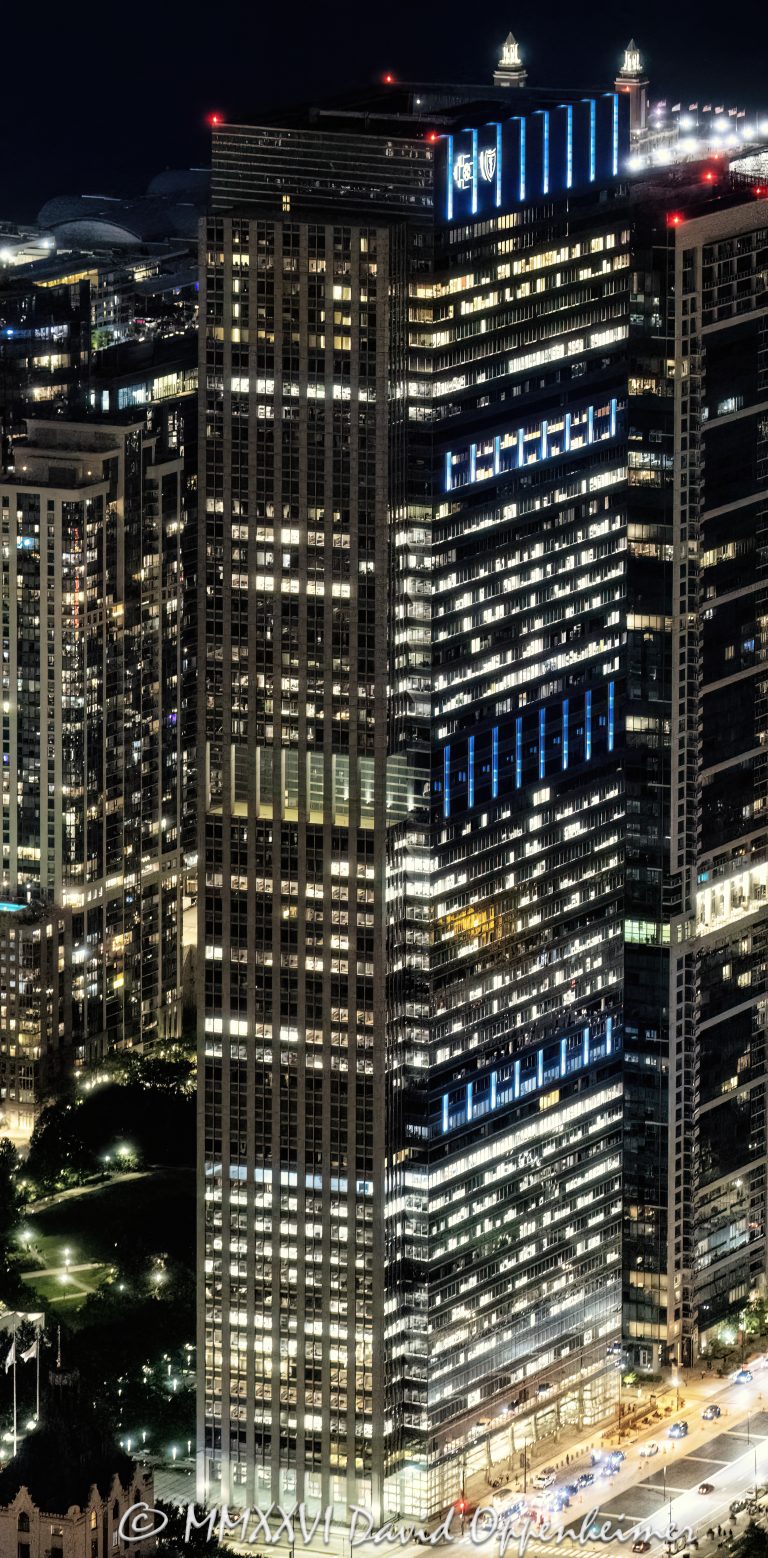 Blue Cross Blue Shield Tower at 300 East Randolph in downtown Chicago, Illinois, located near Millennium Park and Grant Park in the Loop business district. Contemporary commercial skyscraper architecture featuring illuminated office floors, architectural lighting, reflective glass facade design, and dramatic nighttime exterior visibility. The headquarters tower for Health Care Service Corporation was originally designed by Lohan Associates and later vertically expanded by Goettsch Partners. - © 2026 David Oppenheimer - Performance Impressions photography archives https://performanceimpressions.com 300 East Randolph, 300 E Randolph, 300 East Randolph Street, East Randolph Street, Blue Cross Blue Shield Tower, BCBS Tower, Blue Cross Blue Shield Building, Health Care Service Corporation, HCSC, Chicago, Chicago Illinois, Illinois, United States, 60601, Downtown Chicago, Chicago Loop, Millennium Park, Grant Park, architecture, Chicago architecture, architectural photography, urban architecture, modern architecture, contemporary architecture, skyscraper, office tower, high-rise, building, tower, office building, commercial building, corporate tower, corporate headquarters, commercial real estate, corporate real estate, real estate, business district, financial district, commercial architecture, corporate architecture, downtown, urban, glass tower, glass building, glass facade, reflective glass, illuminated building, illuminated windows, office lights, building lights, architectural lighting, nighttime architecture, night photography, night scene, evening light, illuminated facade, lighting design, exterior lighting, reflections, iconic building, American architecture, Illinois architecture, exterior, waterfront, office headquarters, Chicago skyscraper, Chicago office tower, downtown office tower, office architecture, Lohan Associates, Goettsch Partners, Magnusson Klemencic Associates, Blue Cross Blue Shield of Illinois, vertical expansion, commercial photography, commercial imagery, image licensing, licensing, photography licensing, vertical, David Oppenheimer, 1-15156784411