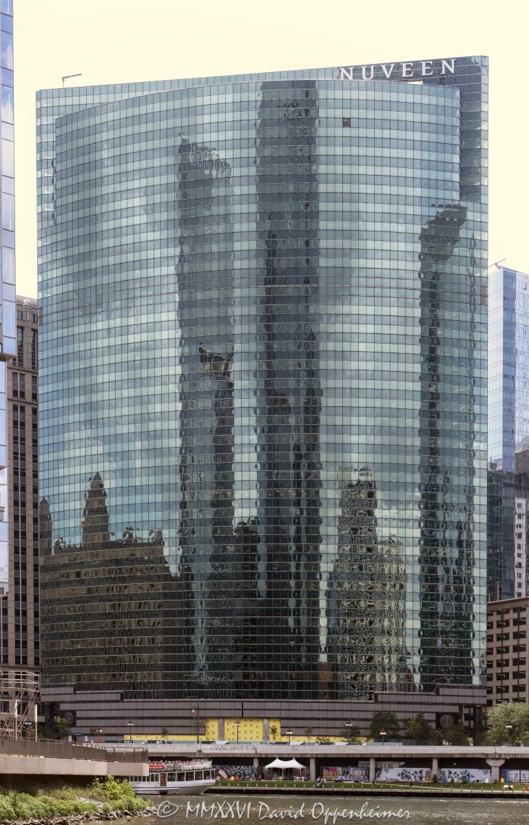333 Wacker Drive curves along the Chicago River in the Loop, with its blue-green glass facade reflecting the riverfront and Chicago Riverwalk below. Designed by Kohn Pedersen Fox, the postmodern office tower is a widely recognized Wacker Drive skyscraper and a Chicago address associated with Nuveen – © 2026 David Oppenheimer – Performance Impressions photography archives https://performanceimpressions.com 333 Wacker Drive, 333 West Wacker Drive, 333 W Wacker Drive, 333 W Wacker Dr, 333 West Wacker, 333 W Wacker, 333 Wacker, 333 Wacker Drive Chicago, 333 West Wacker Chicago, Nuveen 333 Wacker Drive, Nuveen Chicago, Nuveen Investments, Nuveen Asset Management, Nuveen LLC, TIAA, TIAA company, Chicago Loop, Loop Chicago, downtown Chicago, Chicago Illinois, Chicago IL, West Wacker Drive, Wacker Drive, Chicago River, Chicago Riverwalk, Riverwalk Chicago, Chicago riverfront, riverfront, Loop riverfront, Franklin Street, Lake Street, 60606, facade, building exterior, exterior, glass facade, curved glass facade, blue green glass, green glass facade, reflective glass, glass reflection, reflection, river reflection, Chicago River reflection, mirrored facade, office tower, office building, commercial building, Class A office building, skyscraper, high rise, tower, architecture, architectural photography, Chicago architecture, downtown Chicago architecture, riverfront architecture, postmodern architecture, contextual architecture, commercial architecture, Kohn Pedersen Fox, KPF, Kohn Pedersen Fox Associates, William Pedersen, HKS, Hines, Beacon Capital Partners, Nuveen sign, corporate tenant, asset management, investment management, financial services, Ferris Bueller building, Chicago skyline, Illinois architecture, United States, Licensing, image licensing, commercial imagery, photography licensing, art, print, fine art, commercial photography, David Oppenheimer, vertical, 1-15156784411