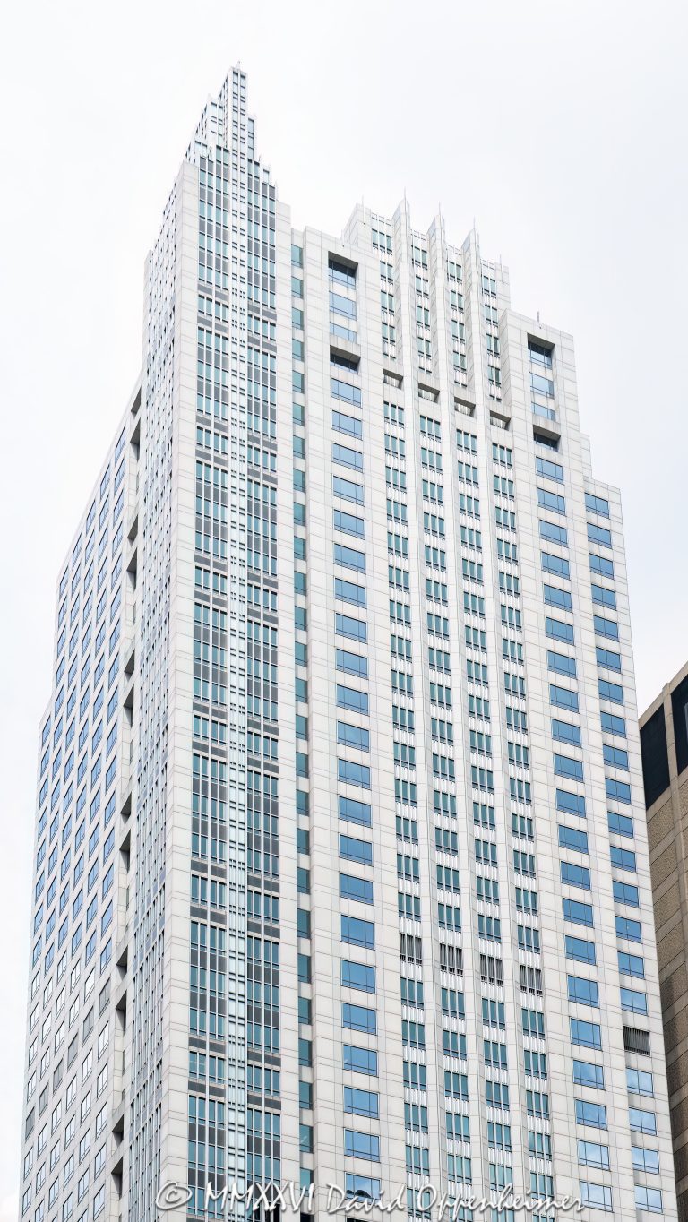 500 West Monroe office tower in Chicago, Illinois, located in the West Loop near Union Station and Ogilvie Transportation Center. Postmodern commercial skyscraper architecture designed by Skidmore, Owings & Merrill featuring a granite and glass exterior, stepped massing, reflective facade, and a distinctive turret-like crown. The 45-story office building was completed in 1992 and was formerly known as the Heller International Building – © 2026 David Oppenheimer – Performance Impressions photography archives https://performanceimpressions.com 500 West Monroe, 500 West Monroe Street, 500 W Monroe, West Monroe Street, Monroe Street, Heller International Building, Heller International Tower, Chicago, Chicago Illinois, Illinois, United States, 60661, Downtown Chicago, West Loop, Chicago Loop, Union Station, Ogilvie Transportation Center, architecture, Chicago architecture, architectural photography, facade, building exterior, exterior, postmodern architecture, modern architecture, contemporary architecture, postmodern skyscraper, skyscraper, high-rise, office tower, building, tower, office building, commercial building, corporate tower, corporate headquarters, commercial real estate, corporate real estate, real estate, business district, financial district, commercial architecture, corporate architecture, downtown, urban, glass tower, glass building, glass facade, reflective glass, granite facade, granite exterior, curtain wall, stepped tower, turret crown, illuminated crown, crown, iconic building, American architecture, Illinois architecture, daylight, financial center, business center, Class A office building, Chicago skyscraper, Chicago office tower, downtown office tower, commercial tower, office architecture, Loop district, West Loop architecture, Skidmore Owings Merrill, Skidmore Owings and Merrill, SOM, Tishman Speyer, Spear Street Capital, JLL, commercial photography, commercial imagery, image licensing, licensing, photography licensing, David Oppenheimer, vertical, 1-15156784411