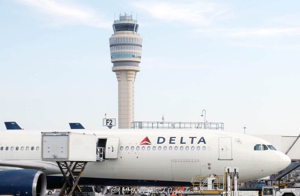 Delta Air Lines Jet and the Air Traffic Control Tower at Hartsfield-Jackson Atlanta International Airport