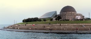 Adler Planetarium and Skyline Walk on the Chicago Lakefront Adler Planetarium and Skyline Walk line Chicago’s Lake Michigan waterfront as people enjoy a summer afternoon along the curved shoreline, with the Art Deco planetarium and glass Sky Pavilion overlooking the water. Located at 1300 South DuSable Lake Shore Drive, the complex combines Ernest A. Grunsfeld Jr.’s original 1930 planetarium with the later pavilion by Lohan Associates – © 2026 David Oppenheimer – Performance Impressions photography archives https://performanceimpressions.com Adler Planetarium and Skyline Walk, Adler Planetarium Skyline Walk, Adler Planetarium, Adler Planetarium Chicago, Skyline Walk, Skyline Walk Chicago, Adler Skyline Walk, Adler Planetarium and Astronomy Museum, 1300 S DuSable Lake Shore Drive, 1300 South DuSable Lake Shore Drive, 1300 S Lake Shore Drive, 1300 South Lake Shore Drive, DuSable Lake Shore Drive, Lake Shore Drive, Museum Campus, Museum Campus Chicago, Northerly Island, Northerly Island Chicago, Northerly Island Park, Solidarity Drive, Near South Side, South Loop, South Loop Chicago, Chicago Illinois, Chicago IL, 60605, Lake Michigan, lake, water, lakefront, waterfront, shoreline, seawall, seawall seating, waterfront seating, lakefront seating, benches, outdoor benches, promenade, walkway, walking path, Lakefront Trail, Chicago Lakefront Trail, people, visitors, tourists, sightseeing, sitting, walking, recreation, outdoors, public space, Chicago lakefront, Chicago waterfront, Lake Michigan waterfront, planetarium, museum, astronomy museum, science museum, space museum, astronomy, science, space, education, attraction, Chicago attraction, tourist attraction, cultural attraction, Chicago museum, first planetarium, historic planetarium, facade, building exterior, exterior, museum exterior, Art Deco, Art Deco facade, granite facade, rainbow granite, copper dome, dome, historic facade, 12 sided building, Sky Pavilion, glass pavilion, curved glass, Doane Observatory, observatory, historic building, landmark building, National Historic Landmark, architecture, architectural photography, Chicago architecture, museum architecture, Art Deco architecture, historic architecture, Ernest A Grunsfeld Jr, Ernest Grunsfeld, Max Adler, Alfonso Iannelli, Lohan Associates, Chicago Park District, Illinois architecture, United States, licensing, image licensing, commercial imagery, photography licensing, art, print, fine art, commercial photography, David Oppenheimer, horizontal, 1-15213827141