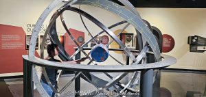 Adler Planetarium Armillary Sphere in Chicago Adler Planetarium armillary sphere and Earth globe on Chicago’s Museum Campus in Chicago, Illinois, with a young visitor examining the Earth-centered astronomical model. Concentric rings illustrate celestial coordinates and the apparent movement of the Sun, connecting astronomy, navigation, geography and historical scientific observation – © 2026 David Oppenheimer – Performance Impressions photography archives https://performanceimpressions.com Adler Planetarium, Adler, Adler Chicago, Adler Planetarium Chicago, Chicago Adler, Adler museum, Adler astronomy, Adler Planetarium interior, Adler exhibit, Adler Planetarium exhibit, armillary sphere, armillary, sphere, Earth globe, globe, Earth, astronomical model, astronomy model, geocentric model, geocentric, Earth-centered, celestial sphere, celestial, celestial coordinates, ecliptic, celestial equator, astronomical instrument, scientific instrument, astronomy, planetarium, museum, science museum, astronomy museum, science, astronomy education, science education, STEM, education, learning, navigation, celestial navigation, geography, cartography, mapping, map, coordinates, latitude, longitude, Sun, solar path, cosmos, universe, astronomy history, historic astronomy, scientific history, concentric rings, rings, astronomy exhibit, science exhibit, museum exhibit, Astronomy in Culture, girl, child, young visitor, museum visitor, student, Chicago Museum Campus, Museum Campus, Museum Campus Chicago, Chicago museum, Chicago museums, Chicago astronomy, Chicago science, Chicago education, Chicago attraction, South Loop, South Loop Chicago, Chicago, Chicago Illinois, Illinois, 1300 South DuSable Lake Shore Drive, 1300 S DuSable Lake Shore Drive, DuSable Lake Shore Drive, 60605, Adler Planetarium and Astronomy Museum, Adler Planetarium & Astronomy Museum, United States, USA, museum photography, astronomy photography, science photography, educational photography, travel photography, editorial photography, licensing, image licensing, commercial imagery, photography licensing, art, print, fine art, commercial photography, David Oppenheimer, Performance Impressions, horizontal, 1-15213827141