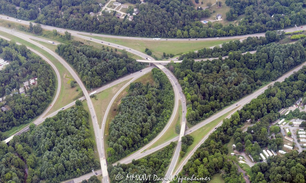 Aerial view of the Interstate 26 and Interstate 40 interchange in Asheville, North Carolina, including I-26, I-40, and I-240 highway infrastructure, ramps, traffic patterns, and road network in Buncombe County, before major reconstruction associated with the Asheville I-26 Connector project – © 2026 David Oppenheimer – Performance Impressions photography archives https://performanceimpressions.com Interstate 26, Interstate 40, I-26, I-40, I-240, Interstate 240, I-26 I-40 interchange, Interstate 26 interchange, Interstate 40 interchange, Asheville I-26 Connector, I-26 Connector project, I-26 Connector, highway interchange, freeway interchange, road interchange, Asheville, Asheville North Carolina, Asheville NC, North Carolina, NC, United States, Buncombe County, Western North Carolina, aerial, aerial photo, aerial photograph, aerial photography, aerial photographer, aerial view, aerial image, aerial perspective, aerial landscape, transportation, transportation infrastructure, highway, freeway, interstate highway, road, roadway, roads, traffic, traffic pattern, ramps, exit ramp, entrance ramp, overpass, bridge, highway ramp, road network, road system, urban planning, civil engineering, infrastructure, transportation engineering, highway construction, reconstruction, highway project, road construction, city from above, American highway, American infrastructure, road photography, documentary photography, editorial photography, commercial photography, commercial imagery, image licensing, licensing, photography licensing, David Oppenheimer, 1-15156784411