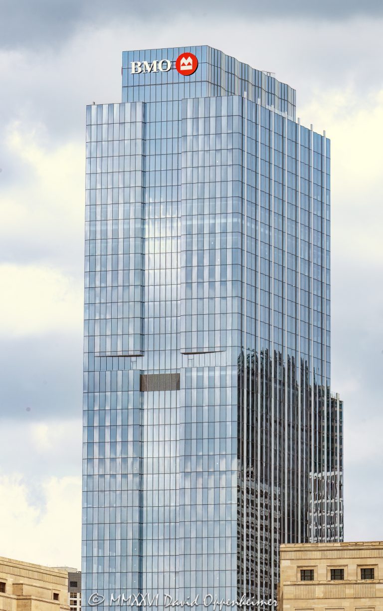 BMO Tower at 320 South Canal in Chicago, Illinois, located in the West Loop Gate area near Chicago Union Station. Contemporary commercial office tower architecture designed by Goettsch Partners featuring a glass facade, terraced setbacks, V-shaped structural framing, and a public park known as The Green at 320. The tower was developed by Riverside Investment & Development and Convexity Properties and opened in 2022 as BMO’s U.S. headquarters – © 2026 David Oppenheimer – Performance Impressions photography archives https://performanceimpressions.com BMO Tower, BMO Tower Chicago, 320 South Canal, 320 South Canal Street, 320 S Canal, South Canal Street, Canal Street, Union Station Tower, BMO, BMO Bank, BMO Harris, BMO Harris Bank, BMO Financial Group, Bank of Montreal, BMO U.S. headquarters, BMO headquarters, bank headquarters, bank building, banking, financial services, corporate office, headquarters building, Chicago, Chicago Illinois, Illinois, United States, 60606, Downtown Chicago, West Loop Gate, West Loop, Chicago Loop, Union Station, Chicago Union Station, Union Station redevelopment, Union Station office tower, architecture, Chicago architecture, architectural photography, facade, building exterior, exterior, modern architecture, contemporary architecture, commercial architecture, corporate architecture, skyscraper, high-rise, office tower, building, tower, office building, commercial building, corporate tower, corporate headquarters, commercial real estate, corporate real estate, real estate, business district, financial district, downtown, urban, glass tower, glass building, glass facade, reflective glass, curtain wall, modern glass tower, contemporary office tower, terraced setbacks, terraced tower, stepped tower, setback design, V-shaped frame, structural frame, structural expression, public park, The Green at 320, The Green, urban park, landscaped park, public plaza, urban plaza, civic space, transit-oriented development, TOD, new construction, office development, commercial development, Class A office building, Class A office tower, Chicago skyscraper, Chicago office tower, downtown office tower, commercial tower, office architecture, Loop district, West Loop architecture, Goettsch Partners, Riverside Investment & Development, Riverside Investment, Convexity Properties, Convexity, Clark Construction, Magnusson Klemencic Associates, commercial photography, commercial imagery, image licensing, licensing, photography licensing, David Oppenheimer, vertical, 1-15156784411