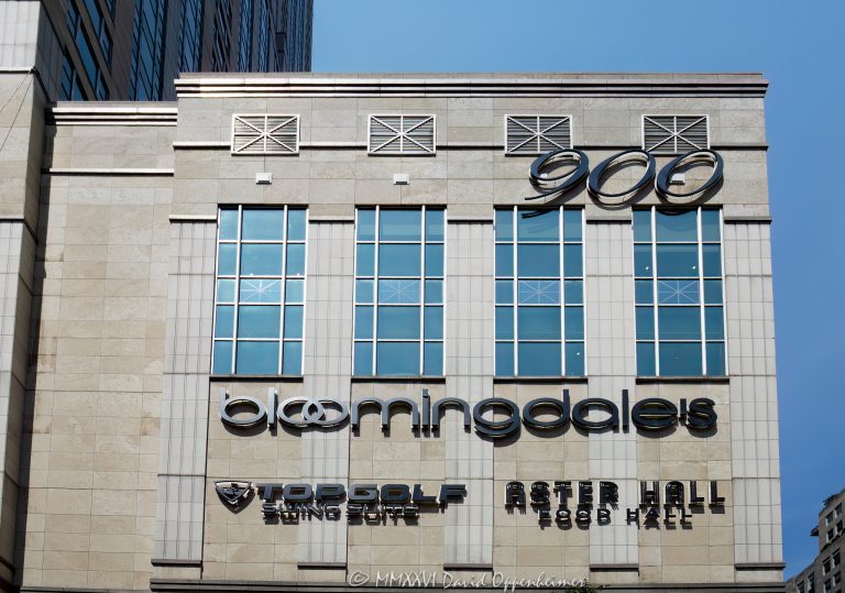 Bloomingdale’s Department Store at 900 North Michigan Shops fronts Chicago’s Magnificent Mile at 900 North Michigan Avenue, with Aster Hall and Topgolf Swing Suite signs visible on the exterior. The store anchors the retail center within the mixed-use tower designed by Kohn Pedersen Fox with Perkins&Will, which also includes offices, private residences, and Four Seasons Hotel Chicago – © 2026 David Oppenheimer – Performance Impressions photography archives https://performanceimpressions.com Bloomingdale’s at 900 North Michigan, Bloomingdale’s Department Store, Bloomingdale’s Chicago, Bloomingdale’s North Michigan Avenue, Bloomingdale’s Michigan Avenue, Bloomingdale’s 900 North Michigan, Bloomingdale’s Building, 900 North Michigan Shops, 900 North Michigan, 900 North Michigan Avenue, 900 N Michigan Avenue, 900 N Michigan Ave, 900 Shops, 900 Shops Chicago, North Michigan Avenue, Michigan Avenue, Magnificent Mile, Mag Mile, Gold Coast, Gold Coast Chicago, Near North Side, downtown Chicago, Chicago Illinois, Chicago IL, Illinois, East Walton Street, Walton Street, East Delaware Place, Delaware Place, 60611, facade, building exterior, exterior, retail facade, department store facade, storefront, store exterior, limestone facade, glass facade, green glass, postmodern facade, signage, building signs, Aster Hall sign, Topgolf sign, shopping center, shopping mall, retail center, retail complex, luxury shopping, Chicago shopping, Michigan Avenue shopping, Magnificent Mile shopping, Gold Coast shopping, shopping, retail, department store, store, fashion, luxury retail, commercial building, mixed use building, mixed use tower, skyscraper, high rise, tower, building, offices, private residences, condominiums, condos, real estate, Chicago real estate, commercial real estate, retail real estate, Magnificent Mile real estate, Aster Hall, Aster Hall Chicago, Aster Hall Food Hall, food hall, dining, restaurants, Topgolf Swing Suite, Top Golf Swing Suite, 900 Swing Suite, Topgolf Chicago, indoor golf, golf simulator, sports simulator, entertainment, Four Seasons Hotel Chicago, Four Seasons Chicago, Four Seasons Hotels and Resorts, Bloomingdale’s, Macy’s Inc, Macy’s, Kohn Pedersen Fox, KPF, Perkins&Will, Perkins and Will, JMB Realty, JMB Realty Corporation, Urban Retail Properties, Alfred Benesch, postmodern architecture, retail architecture, commercial architecture, Chicago architecture, architectural photography, Illinois architecture, United States, licensing, image licensing, commercial imagery, photography licensing, art, print, fine art, commercial photography, David Oppenheimer, horizontal, 1-15213827141