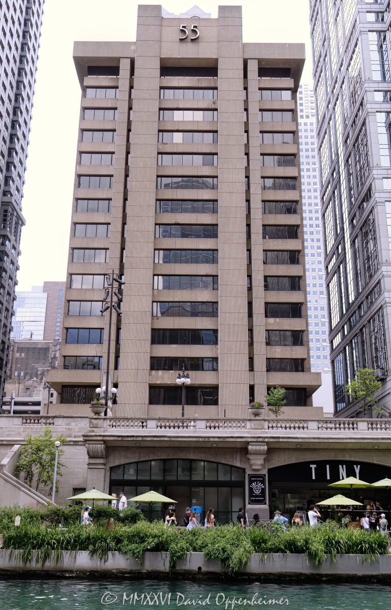 55 West Wacker office building in Chicago, Illinois, located along the Chicago River in the Loop business district. Brutalist commercial architecture designed by C.F. Murphy Associates featuring a concrete facade, deep-set windows, and a strong riverfront office presence near Wacker Drive and Dearborn Street. Built in 1968 as the Blue Cross Blue Shield of Illinois headquarters, the 16-story building is also historically known as the Blue Cross-Blue Shield Building – © 2026 David Oppenheimer – Performance Impressions photography archives https://performanceimpressions.com 55 West Wacker, 55 West Wacker Drive, 55 W Wacker, West Wacker Drive, Wacker Drive, Blue Cross-Blue Shield Building, Blue Cross Blue Shield Building, former Blue Cross Blue Shield headquarters, Blue Cross Blue Shield of Illinois, Chicago, Chicago Illinois, Illinois, United States, 60601, Downtown Chicago, Chicago Loop, Chicago River, Chicago riverfront, architecture, Chicago architecture, architectural photography, facade, building exterior, exterior, Brutalist architecture, brutalism, concrete facade, concrete building, concrete tower, deep-set windows, recessed windows, modern architecture, commercial architecture, office architecture, office tower, office building, commercial building, building, tower, high-rise, commercial real estate, corporate real estate, real estate, business district, financial district, corporate architecture, downtown, urban, riverfront architecture, riverfront building, riverfront office building, iconic building, American architecture, Illinois architecture, daylight, waterfront, financial center, business center, Class A office building, Chicago office tower, downtown office tower, C.F. Murphy Associates, CF Murphy Associates, C F Murphy Associates, Pearl Properties, Taipei Economic and Cultural Office, TECO Chicago, commercial photography, commercial imagery, image licensing, licensing, photography licensing, David Oppenheimer, vertical, 1-15156784411