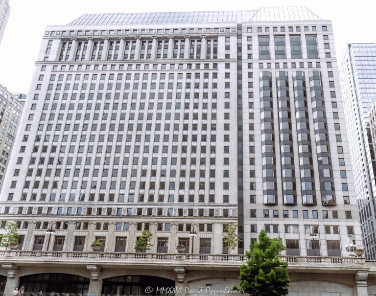 Builders Building at 222 North LaSalle Street in Chicago, Illinois, located along the Chicago River in the Loop business district. Historic commercial office architecture designed by Graham, Anderson, Probst & White featuring a classical stone facade, riverfront positioning, and modernized office space within the West Loop–LaSalle Street Historic District. Built in 1927 and later expanded and renovated by Skidmore, Owings & Merrill, the building is also known as 222 North LaSalle – © 2026 David Oppenheimer – Performance Impressions photography archives https://performanceimpressions.com Builders Building, Builders BLDG, 222 North LaSalle, 222 North LaSalle Street, 222 N LaSalle, 222 N LaSalle Street, North LaSalle Street, LaSalle Street, Chicago, Chicago Illinois, Illinois, United States, 60601, Downtown Chicago, Chicago Loop, Chicago River, Chicago riverfront, Chicago Riverwalk, architecture, Chicago architecture, architectural photography, facade, building exterior, exterior, historic architecture, classical architecture, neoclassical architecture, Beaux-Arts architecture, commercial architecture, office architecture, office tower, office building, commercial building, building, tower, high-rise, stone facade, limestone facade, classical facade, historic facade, riverfront architecture, riverfront building, riverfront office building, commercial real estate, corporate real estate, real estate, business district, financial district, corporate architecture, downtown, urban, historic building, historic district, West Loop-LaSalle Street Historic District, American architecture, Illinois architecture, daylight, waterfront, financial center, business center, Class A office building, Chicago office tower, downtown office tower, Graham Anderson Probst White, Graham Anderson Probst and White, GAPW, Skidmore Owings Merrill, Skidmore Owings and Merrill, SOM, Tishman Speyer, Turner Construction, commercial photography, commercial imagery, image licensing, licensing, photography licensing, David Oppenheimer, horizontal, 1-15156784411