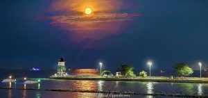 Full Moon Rising Over Chicago Harbor Southeast Guidewall Lighthouse Full moon rising above the Chicago Harbor Southeast Guidewall Lighthouse marks the Lake Michigan entrance to the Chicago River, viewed from Offshore Rooftop at Navy Pier. The harbor channel, guidewall and breakwater lead through the scene with several boats on the water, creating a layered Chicago waterfront composition in Chicago, Illinois – © 2026 David Oppenheimer – Performance Impressions photography archives https://performanceimpressions.com Chicago Harbor Southeast Guidewall Lighthouse, Chicago Harbor Southeast Guidewall Light, Chicago Harbor Southeast Guidewall, Southeast Guidewall Lighthouse, Chicago guidewall lighthouse, Chicago lighthouse, Lake Michigan lighthouse, full moon, full moon rising, moonrise, moon, lunar, moonlight, moonlit, glowing moon, moon photography, lunar photography, full moon photography, moon over lighthouse, full moon lighthouse, lighthouse moon, lighthouse, harbor lighthouse, guidewall light, navigation light, navigation aid, beacon, harbor beacon, lighthouse photography, Chicago Harbor, Chicago harbor entrance, Chicago River entrance, Chicago River mouth, Chicago River, Lake Michigan, Great Lakes, Chicago lakefront, Chicago waterfront, lakefront, waterfront, harbor, channel, harbor channel, navigation channel, guidewall, south guidewall, southeast guidewall, breakwater, breakwater structure, harbor entrance, maritime navigation, marine navigation, boating, boats, moored boats, anchored boats, recreational boats, pleasure boats, Offshore Rooftop, Offshore Rooftop Chicago, Offshore Chicago, Offshore Rooftop & Bar, Navy Pier, Navy Pier Chicago, 1000 East Grand, 1000 E Grand Ave, Festival Hall, Chicago rooftop, rooftop, rooftop view, Streeterville, Streeterville Chicago, Near North Side, downtown Chicago, Chicago, Chicago Illinois, Chicago IL, Illinois, 60611, Chicago Harbor Lock, Chicago Lock, harbor lock, navigation lock, lock, USACE, U.S. Army Corps of Engineers, US Army Corps of Engineers, USACE Chicago District, Chicago District, Illinois Waterway, U.S. Coast Guard, US Coast Guard, USCG, maritime, nautical, waterfront photography, harbor photography, maritime photography, nautical photography, landscape photography, urban landscape, fine art photography, art photography, contemporary photography, creative photography, surreal photography, surreal, surrealism, photorealism, photo realism, photorealistic, painterly, painterly photography, lighthouse art, lighthouse print, lighthouse wall art, moon art, full moon art, lunar art, moon print, moon wall art, nautical art, maritime art, harbor art, Lake Michigan art, Chicago art, Chicago photography, Chicago wall art, Navy Pier art, fine art print, photographic print, archival print, gallery print, collector print, collectible art, art print, wall art, wall decor, luxury decor, home decor, office decor, interior design, statement art, art collector, photography collector, lighthouse collector, Maverick Hotels & Restaurants, Maverick Hotels and Restaurants, Navy Pier Inc, United States, licensing, image licensing, commercial imagery, photography licensing, art, print, fine art, commercial photography, David Oppenheimer, horizontal, 1-15213827141
