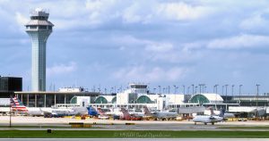 ATC Tower and American Airlines Terminal 3 at Chicago O’Hare Airport ATC Tower and American Airlines Terminal 3 at Chicago O’Hare Airport in Chicago, Illinois, shown from the tarmac with aircraft, gates, jet bridges, taxiways, and terminal architecture. Daytime view of American Airlines and American Eagle operations near Terminal 3 Concourse G, including arched roof structures, commercial aircraft, and airport ramp activity – © 2026 David Oppenheimer – Performance Impressions photography archives https://performanceimpressions.com Chicago O’Hare International Airport, O’Hare International Airport, O’Hare Airport, Chicago O’Hare, O’Hare, ORD, ORD Airport, Chicago airport, airport, ATC tower, air traffic control tower, control tower, FAA tower, airport tower, American Airlines, American Airlines jets, AA, AA jets, American Eagle, aircraft, airplane, airplanes, jet, jets, passenger jet, commercial aircraft, Terminal 3, Terminal 3 Concourse G, Concourse G, terminal concourse, airport terminal, airline terminal, passenger terminal, terminal, terminal building, terminal architecture, arched roof, airport architecture, aviation, commercial aviation, airline, airlines, airport operations, airline operations, ground operations, airport ramp, ramp area, airport tarmac, tarmac, airport apron, taxiway, jet bridge, gate area, airport gate, aircraft gates, airport infrastructure, aviation infrastructure, airport scene, air travel, travel, transportation, transportation infrastructure, modern architecture, urban infrastructure, Chicago, Chicago Illinois, Illinois, United States, 60666, daytime, city airport, Midwest aviation, aviation industry, transportation hub, hub airport, O’Hare terminal, O’Hare tower, photorealism, photorealistic, digital art, artwork, rich color, saturated color, commercial photography, commercial imagery, image licensing, licensing, photography licensing, David Oppenheimer, horizontal, 1-15156784411