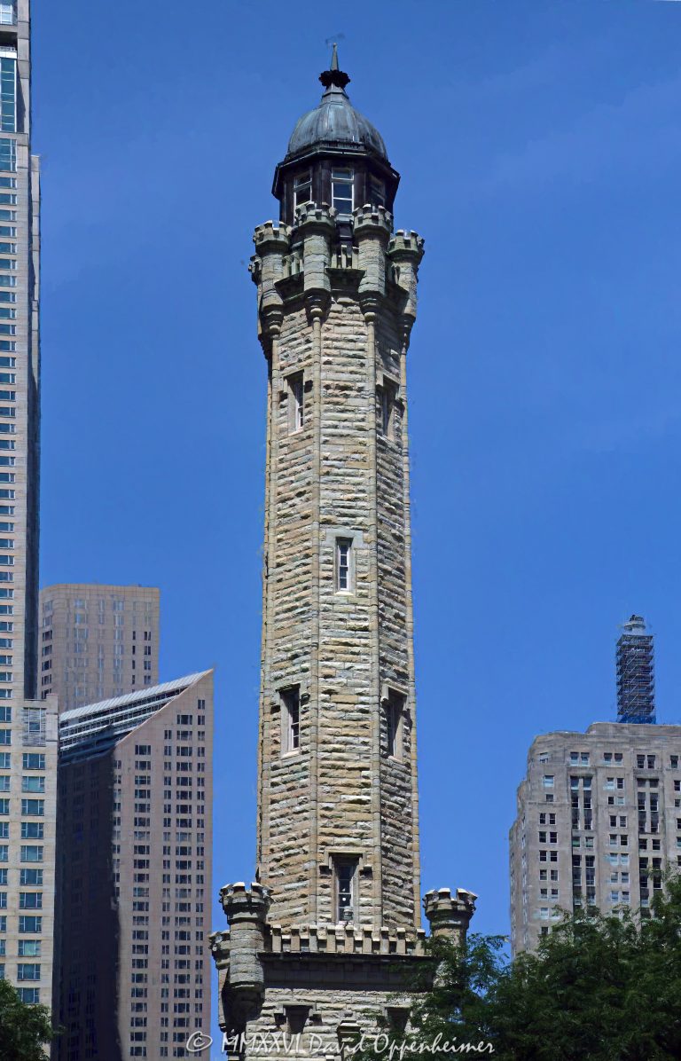 Chicago Water Tower at 806 North Michigan Avenue in Chicago, Illinois, shown in a vertical daytime view emphasizing its limestone stonework, castellated Gothic Revival detailing, turrets, pointed arches, and tower profile. Designed by William W. Boyington to house a standpipe for the Chicago Avenue waterworks system, the landmark survived the Great Chicago Fire of 1871 and remains a defining structure on the Magnificent Mile – © 2026 David Oppenheimer – Performance Impressions photography archives https://performanceimpressions.com Chicago Water Tower, Historic Chicago Water Tower, Chicago Avenue Water Tower, Chicago Avenue Water Tower and Pumping Station, 806 North Michigan Avenue, 806 N Michigan Avenue, North Michigan Avenue, Michigan Avenue, Magnificent Mile, Mag Mile, Near North Side, Streeterville, Jane M Byrne Plaza, Chicago, Chicago Illinois, Chicago IL, Illinois, 60611, facade, building exterior, exterior, tower exterior, stone facade, limestone facade, stonework, masonry, limestone, Joliet limestone, Lemont limestone, Gothic Revival, Gothic Revival architecture, castellated Gothic, historic architecture, landmark architecture, Chicago architecture, vertical architecture, architecture, architectural photography, tower, water tower, historic tower, standpipe, standpipe tower, waterworks, water supply, municipal infrastructure, infrastructure, Chicago Water Works, Chicago Avenue Pumping Station, City Gallery, City Gallery in the Historic Water Tower, Water Tower Place, Great Chicago Fire, fire survivor, Chicago history, historic landmark, Chicago Landmark, National Register of Historic Places, Old Chicago Water Tower District, American Water Landmark, William W Boyington, William Boyington, Ellis S Chesbrough, pointed arches, lancet windows, crenellations, battlements, turrets, spire, buttresses, parapet, ornate stone, daytime, daylight, tourism, travel, destination, landmark, historic, building, United States, licensing, image licensing, commercial imagery, photography licensing, art, print, fine art, commercial photography, David Oppenheimer, vertical, 1-15213827141