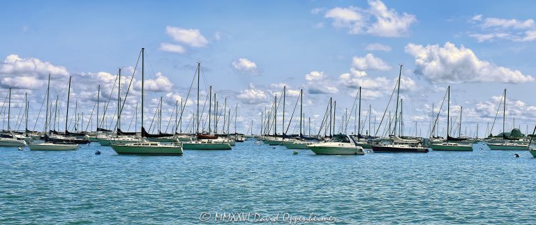 Chicago Yacht Club’s Monroe Station at 400 East Monroe Street overlooks sailboats moored across Monroe Harbor on Lake Michigan, viewed from the lakefront beside Grant Park on a clear summer day. The harbor and clubhouse form a defining sailing scene along the downtown waterfront in Chicago, Illinois – © 2026 David Oppenheimer – Performance Impressions photography archives https://performanceimpressions.com Chicago Yacht Club, Chicago Yacht Club Chicago, Chicago Yacht Club Monroe Station, CYC, Monroe Station, Monroe clubhouse, Chicago Yacht Club clubhouse, 400 East Monroe Street, 400 E Monroe Street, 400 E Monroe St, Monroe Harbor, Monroe Harbor Chicago, Chicago Monroe Harbor, Chicago sailing, Chicago sailboats, Chicago yacht club, Chicago yachting, Chicago boating, sailing, sailboats, sailboat, moored sailboats, moored boats, sailboat mooring, mooring field, moorings, mooring cans, yachts, yacht, yachting, yacht club, sailing club, clubhouse, boating, boats, recreational boating, pleasure boats, sailing boats, Lake Michigan sailing, Lake Michigan boating, Great Lakes sailing, Great Lakes boating, Lake Michigan, Great Lakes, Chicago lakefront, Chicago waterfront, lakefront, waterfront, harbor, harbor view, harbor scene, sailing harbor, boating harbor, downtown harbor, shoreline, lakeshore, lake view, water, Grant Park, Grant Park Chicago, Lakefront Park, Chicago Lakefront Park, Lakefront Trail, Monroe Street, Chicago Loop, Loop, downtown Chicago, Chicago, Chicago Illinois, Chicago IL, Illinois, 60603, summer, summertime, summer day, Chicago summer, summer sailing, blue sky, puffy clouds, white clouds, fair weather, clear day, calm water, scenic waterfront, scenic harbor, waterfront recreation, lakefront recreation, outdoor recreation, maritime, nautical, marine, boating lifestyle, sailing lifestyle, sailing culture, sailboat racing, yacht racing, regatta, regattas, Chicago regatta, Race to Mackinac, Mackinac Race, Chicago Yacht Club Race to Mackinac, offshore sailing, sailing competition, Chicago Harbors, Chicago Park District, Westrec, Westrec Marina Management, harbor system, urban waterfront, urban lakefront, waterfront photography, sailing photography, sailboat photography, yacht photography, harbor photography, maritime photography, nautical photography, landscape photography, Chicago photography, Chicago art, lakefront art, sailing art, sailboat art, yacht art, fine art photography, photographic print, fine art print, wall art, United States, licensing, image licensing, commercial imagery, photography licensing, art, print, fine art, commercial photography, David Oppenheimer, horizontal, 1-15213827141