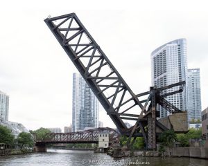 Chicago and North Western Railway Kinzie Street Bridge Raised Over Chicago River Chicago and North Western Railway Kinzie Street Bridge raised over the North Branch of the Chicago River in downtown Chicago, Illinois. Historic single-leaf bascule railroad bridge near Kinzie Street and Canal Street, also known as the Carroll Avenue Bridge, built in 1908 and designated a Chicago Landmark in 2007. The raised steel bridge is a former Chicago and North Western railroad span now owned by Union Pacific – © 2026 David Oppenheimer – Performance Impressions photography archives https://performanceimpressions.com Chicago and North Western Railway Bridge, Chicago & North Western Railway Bridge, Chicago and North Western Railroad Bridge, Chicago & North Western Railroad Bridge, Kinzie Street railroad bridge, Kinzie Street Railroad Bridge, Kinzie Street Bridge, Carroll Avenue Bridge, C&NW bridge, C&NW railroad bridge, Union Pacific bridge, Union Pacific Railroad, raised bridge, bridge, raised railroad bridge, open bridge, bascule bridge, single-leaf bascule bridge, railroad bridge, railway bridge, rail bridge, train bridge, steel bridge, steel girders, bridge girders, metal girders, steel truss, truss bridge, railroad truss, steel structure, bridge structure, riveted steel, steelwork, historic bridge, landmark bridge, Chicago Landmark, Chicago bridge, Chicago bridges, Chicago railroad bridge, Chicago railway bridge, Chicago River bridge, Chicago River, North Branch Chicago River, North Branch, Kinzie Street, Canal Street, Wolf Point, downtown Chicago, Chicago Loop, River North, Near West Side, Chicago, Chicago Illinois, Illinois, United States, 60654, architecture, Chicago architecture, architectural photography, bridge architecture, engineering, civil engineering, structural engineering, industrial architecture, transportation, transportation infrastructure, rail infrastructure, railroad infrastructure, railway infrastructure, railroad history, railway history, Chicago history, industrial history, historic infrastructure, urban infrastructure, bridge photography, railroad photography, rail photography, infrastructure photography, documentary photography, editorial photography, commercial photography, commercial imagery, image licensing, licensing, photography licensing, David Oppenheimer, horizontal, 1-15156784411