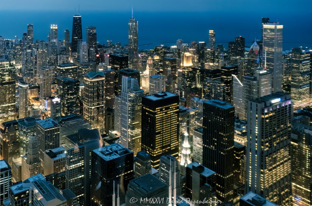 Chicago skyline and city lights at night from Willis Tower in Chicago, Illinois, looking north across downtown toward the Magnificent Mile, Gold Coast, and 875 North Michigan Avenue. Elevated nighttime view from the former Sears Tower showing the Chicago Loop, Richard J. Daley Center at 50 West Washington Street, North Michigan Avenue, 900 North Michigan Shops, 360 Chicago, high-rise buildings, illuminated streets, and downtown neighborhoods – © 2026 David Oppenheimer – Performance Impressions aerial photography archives https://performanceimpressions.com Chicago skyline, Chicago skyline at night, Chicago city lights, city lights, night skyline, nighttime skyline, Chicago at night, downtown Chicago, Chicago downtown, Chicago Loop, Loop, financial district, Magnificent Mile, North Michigan Avenue, Michigan Avenue, Gold Coast, Near North Side, River North, Streeterville, 875 North Michigan Avenue, 875 North Michigan, John Hancock Center, former John Hancock Center, 360 Chicago, 360 Chicago Observation Deck, 900 North Michigan, 900 North Michigan Avenue, 900 North Michigan Shops, 50 West Washington, 50 West Washington Street, Richard J. Daley Center, Daley Center, Chicago River, Chicago Riverwalk, Lake Michigan, Chicago lakefront, skyline, cityscape, Chicago cityscape, aerial, aerial photo, aerial photography, aerial photographer, aerial view, aerial image, night aerial, nighttime aerial, night photography, night photo, city at night, urban night, illuminated city, illuminated streets, street lights, building lights, high-rise, high-rises, skyscraper, skyscrapers, building, tower, architecture, Chicago architecture, urban architecture, modern architecture, contemporary architecture, downtown skyline, urban skyline, office towers, residential towers, condo towers, hotel towers, glass towers, glass buildings, city from above, Willis Tower, Sears Tower, former Sears Tower, Skydeck Chicago, 233 South Wacker, 233 South Wacker Drive, 233 S Wacker, Illinois, Chicago Illinois, United States, licensing, image licensing, commercial imagery, photography licensing, art, print, fine art, commercial photography, David Oppenheimer, horizontal, 1-15156784411