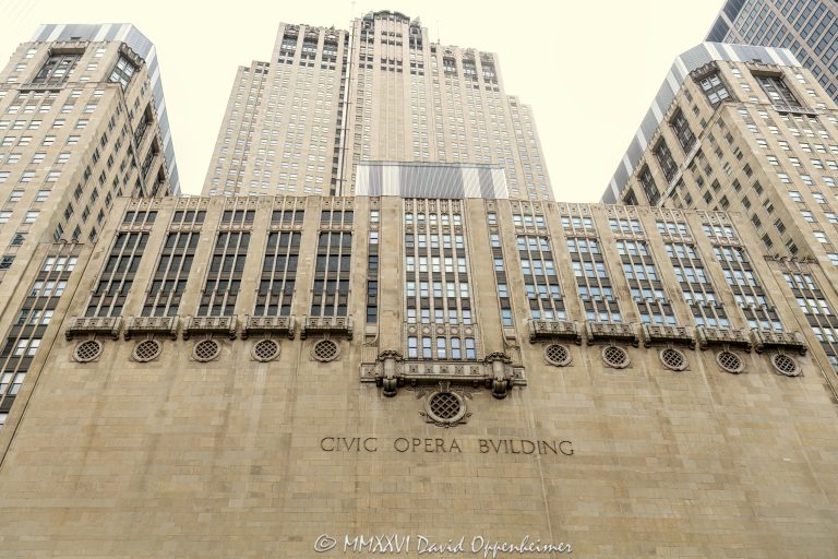 Civic Opera Building and Lyric Opera House at 20 North Wacker Drive in Chicago, Illinois, seen from the Chicago River in the Loop business district. Historic Art Deco commercial and performing arts architecture designed by Graham, Anderson, Probst & White featuring a limestone facade, riverfront massing, office tower, and opera house for Lyric Opera of Chicago. The 1929 building is also associated with The Florian at Lyric Opera and is designated a Chicago Landmark – © 2026 David Oppenheimer – Performance Impressions photography archives https://performanceimpressions.com Civic Opera Building, Civic Opera House, Lyric Opera House, Lyric Opera of Chicago, Chicago Civic Opera, The Florian, The Florian at Lyric Opera, Florian Chicago, 20 North Wacker, 20 North Wacker Drive, 20 N Wacker, Twenty North Wacker, North Wacker Drive, Wacker Drive, Chicago River, Chicago riverfront, Chicago Riverwalk, Chicago, Chicago Illinois, Illinois, United States, 60606, Downtown Chicago, Chicago Loop, Loop, financial district, architecture, Chicago architecture, architectural photography, facade, building exterior, exterior, Art Deco, Art Deco architecture, historic architecture, landmark building, Chicago Landmark, historic building, limestone facade, stone facade, riverfront architecture, performing arts, opera house, opera, theater, theatre, office tower, office building, commercial building, building, tower, high-rise, commercial real estate, corporate real estate, real estate, business district, downtown, urban, waterfront, daylight, American architecture, Illinois architecture, Graham Anderson Probst White, Graham Anderson Probst and White, Graham Anderson, Probst and White, GAPW, Samuel Insull, Henry Hering, Kemper Insurance Building, commercial photography, commercial imagery, image licensing, licensing, photography licensing, art, print, fine art, David Oppenheimer, horizontal, 1-15156784411
