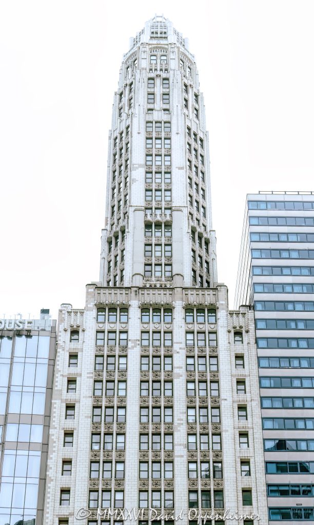 Club Quarters Hotel Wacker at Michigan at 75 East Upper Wacker Drive in Chicago, Illinois, occupies the historic Mather Tower, a slender Neo-Gothic terra-cotta high-rise overlooking the Chicago River. Designed by Herbert Hugh Riddle for Alonzo C. Mather, the landmark tower stands near Michigan Avenue, the Riverwalk, the Magnificent Mile, and the Chicago Loop – © 2026 David Oppenheimer – Performance Impressions photography archives https://performanceimpressions.com Club Quarters Hotel Wacker at Michigan, Club Quarters Hotel, Club Quarters Chicago, Club Quarters, CQ Hotels, CQ Hotel, Mather Tower, 75 East Upper Wacker Drive, 75 E Upper Wacker Drive, 75 East Wacker Drive, 75 E Wacker Drive, East Wacker Drive, Wacker Drive, Michigan Avenue, North Michigan Avenue, Chicago River, Chicago Riverwalk, Riverwalk, riverfront, downtown Chicago, Chicago Loop, Loop Chicago, Near North Side, River North, Magnificent Mile, Mag Mile, Chicago, Chicago Illinois, Chicago IL, Illinois, 60601, facade, building exterior, exterior, tower exterior, hotel exterior, terra cotta facade, terra cotta, Gothic terra cotta, Neo-Gothic, Neo-Gothic architecture, Gothic Revival, Modernistic skyscraper, Jazz Age architecture, historic architecture, Chicago architecture, high-rise architecture, architecture, architectural photography, hotel, hotel tower, riverfront hotel, downtown hotel, Chicago hotel, business hotel, business travel, hospitality, travel, tourism, destination, tower, skyscraper, high rise, slender tower, setback tower, landmark tower, historic tower, octagonal tower, cupola, vertical tower, city views, river views, Mather Stock Car Company, Alonzo C Mather, Herbert Hugh Riddle, W A Illsey, R F Wilson and Company, Overland Construction Company, Northwestern Terra Cotta, Chicago Landmark, Michigan Wacker Historic District, National Register of Historic Places, River Hotel, 75 East Wacker, real estate, hotel real estate, commercial real estate, Chicago real estate, United States, licensing, image licensing, commercial imagery, photography licensing, art, print, fine art, commercial photography, David Oppenheimer, vertical, 1-15213827141
