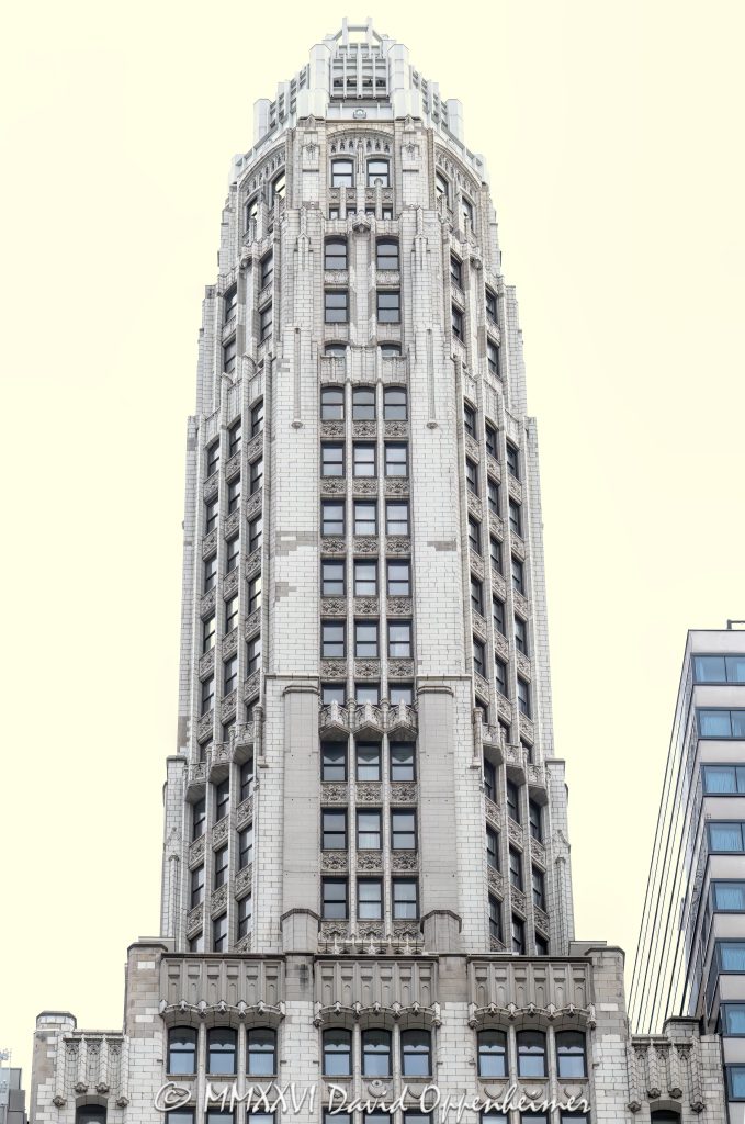 Club Quarters Hotel Wacker at Michigan at 75 East Upper Wacker Drive in Chicago, Illinois, occupies the historic Mather Tower, a slender Neo-Gothic terra-cotta high-rise overlooking the Chicago River. Designed by Herbert Hugh Riddle for Alonzo C. Mather, the landmark tower stands near Michigan Avenue, the Riverwalk, the Magnificent Mile, and the Chicago Loop – © 2026 David Oppenheimer – Performance Impressions photography archives https://performanceimpressions.com Club Quarters Hotel Wacker at Michigan, Club Quarters Hotel, Club Quarters Chicago, Club Quarters, CQ Hotels, CQ Hotel, Mather Tower, 75 East Upper Wacker Drive, 75 E Upper Wacker Drive, 75 East Wacker Drive, 75 E Wacker Drive, East Wacker Drive, Wacker Drive, Michigan Avenue, North Michigan Avenue, Chicago River, Chicago Riverwalk, Riverwalk, riverfront, downtown Chicago, Chicago Loop, Loop Chicago, Near North Side, River North, Magnificent Mile, Mag Mile, Chicago, Chicago Illinois, Chicago IL, Illinois, 60601, facade, building exterior, exterior, tower exterior, hotel exterior, terra cotta facade, terra cotta, Gothic terra cotta, Neo-Gothic, Neo-Gothic architecture, Gothic Revival, Modernistic skyscraper, Jazz Age architecture, historic architecture, Chicago architecture, high-rise architecture, architecture, architectural photography, hotel, hotel tower, riverfront hotel, downtown hotel, Chicago hotel, business hotel, business travel, hospitality, travel, tourism, destination, tower, skyscraper, high rise, slender tower, setback tower, landmark tower, historic tower, octagonal tower, cupola, vertical tower, city views, river views, Mather Stock Car Company, Alonzo C Mather, Herbert Hugh Riddle, W A Illsey, R F Wilson and Company, Overland Construction Company, Northwestern Terra Cotta, Chicago Landmark, Michigan Wacker Historic District, National Register of Historic Places, River Hotel, 75 East Wacker, real estate, hotel real estate, commercial real estate, Chicago real estate, United States, licensing, image licensing, commercial imagery, photography licensing, art, print, fine art, commercial photography, David Oppenheimer, vertical, 1-15213827141