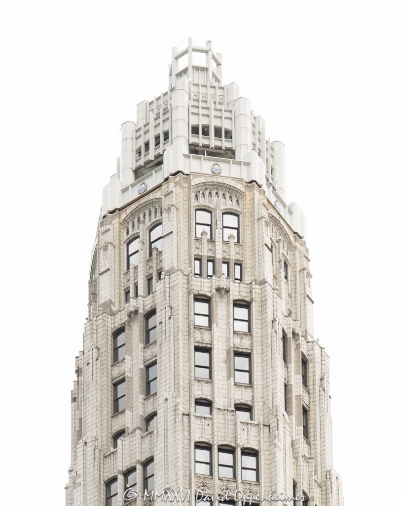 Club Quarters Hotel, Wacker at Michigan in Chicago, Illinois, located at 75 East Wacker Drive near Michigan Avenue, the Chicago River, and the Magnificent Mile. The hotel is housed in historic Mather Tower, a Neo-Gothic high-rise known for its slender white terra cotta tower and riverfront location. This vertical close-up shows the upper tower in soft overcast light, emphasizing the pale facade, historic detail, and light-box appearance of the building – © 2026 David Oppenheimer – Performance Impressions photography archives https://performanceimpressions.com Club Quarters Hotel, Club Quarters Chicago, Club Quarters Hotel Wacker at Michigan, Club Quarters Wacker at Michigan, CQ Hotels, Club Quarters, Mather Tower, Mather Tower Chicago, Lincoln Tower, 75 East Wacker, 75 East Wacker Drive, 75 E Wacker, East Wacker Drive, Wacker Drive, Michigan Avenue, Chicago River, Chicago Riverwalk, Magnificent Mile, Chicago, Chicago Illinois, Illinois, United States, 60601, Downtown Chicago, Chicago Loop, Loop, architecture, Chicago architecture, architectural photography, facade, building exterior, exterior, historic architecture, Neo-Gothic architecture, Gothic Revival, terra cotta, white terra cotta, terra cotta facade, white facade, pale facade, ornate facade, tower detail, upper tower, slender tower, high-rise, skyscraper, building, tower, hotel building, hotel architecture, hospitality architecture, boutique hotel, business hotel, riverfront hotel, downtown hotel, Chicago hotel, historic hotel, commercial architecture, commercial building, commercial real estate, hotel real estate, real estate, historic building, Chicago Landmark, landmark building, white building, overcast, cloudy sky, soft light, daylight, urban architecture, American architecture, Illinois architecture, downtown, urban, travel, tourism, commercial photography, commercial imagery, image licensing, licensing, photography licensing, art, print, fine art, David Oppenheimer, vertical, 1-15156784411