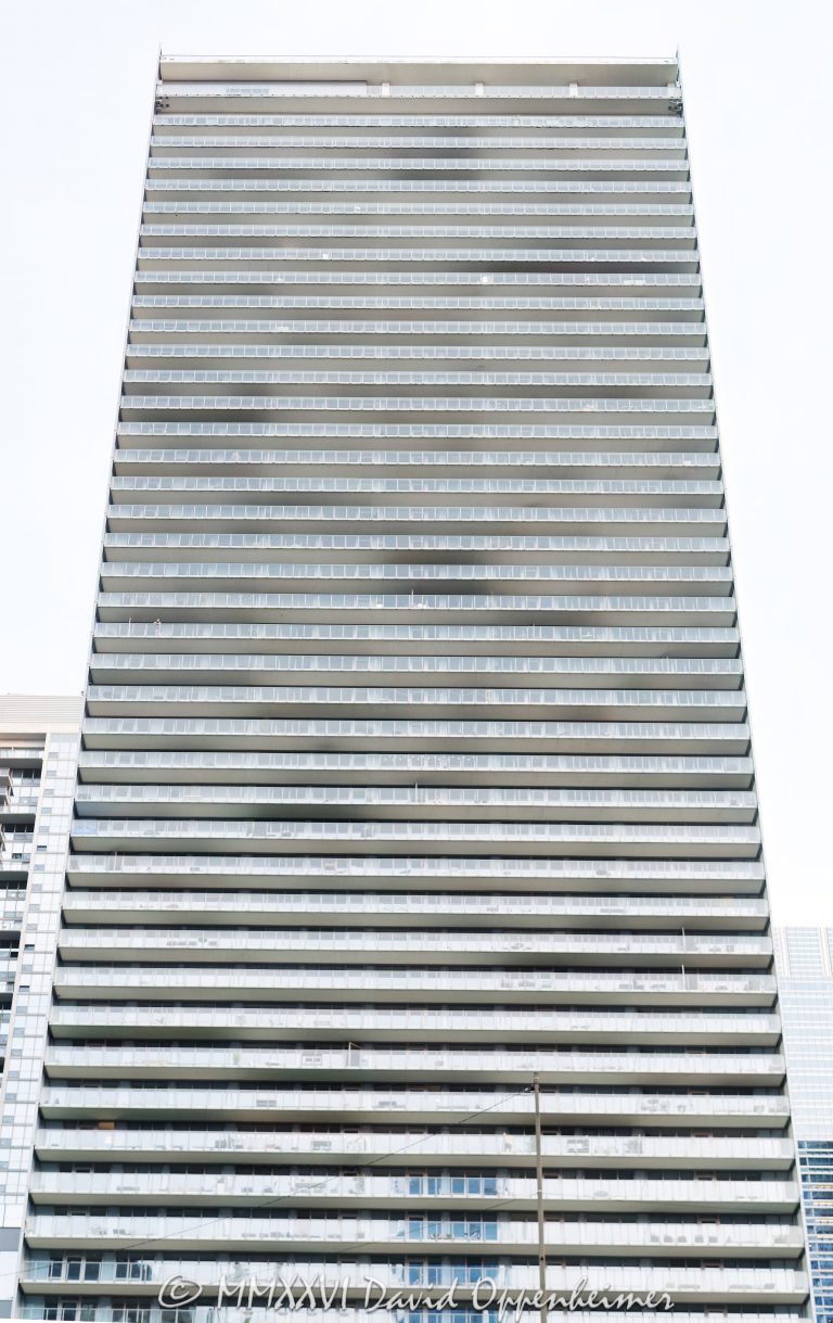 Coast at Lakeshore East at 345 East Wacker Drive in Chicago, Illinois, shown in a vertical exterior view of the rectangular glass rental tower with continuous balconies and a high-rise facade. Designed by bKL Architecture with Loewenberg Architects as architect of record and developed by Magellan Development Group, the Lakeshore East apartment building stands near the Chicago River, Lake Michigan, and Millennium Park – © 2026 David Oppenheimer – Performance Impressions photography archives https://performanceimpressions.com Coast at Lakeshore East, Coast Chicago, COAST, Coast Apartments, Coast at Lakeshore East Apartments, 345 East Wacker Drive, 345 E Wacker Drive, East Wacker Drive, Wacker Drive, Lakeshore East, New Eastside, Lakeshore East Chicago, New Eastside Chicago, downtown Chicago, Chicago Loop, Loop Chicago, Chicago, Chicago Illinois, Chicago IL, Illinois, 60601, facade, building exterior, exterior, tower exterior, glass facade, glass tower, glass high rise, rectangular tower, rectangular facade, curtain wall, glass curtain wall, aluminum window wall, translucent glass, fritted glass, Low-E glass, balconies, continuous balconies, glass balconies, glass handrails, horizontal balconies, apartment tower, residential tower, rental tower, high rise, high-rise, skyscraper, tower, building, apartment building, residential building, rental building, mixed-use tower, apartments, rental apartments, luxury apartments, Chicago apartments, downtown apartments, Lakeshore East apartments, New Eastside apartments, urban apartments, multifamily, multifamily housing, residential real estate, apartment real estate, Chicago real estate, Lakeshore East real estate, lakefront real estate, riverfront real estate, commercial real estate, real estate, Chicago River, riverfront, waterfront, lakefront, Lake Michigan, Millennium Park, Lakeshore East Park, Grant Park, DuSable Harbor, Chicago Harbor, architecture, architectural photography, Chicago architecture, residential architecture, high-rise architecture, modern architecture, Chicago modernism, bKL Architecture, bKL Architects, Loewenberg Architects, Magellan Development Group, James McHugh Construction, McHugh Construction, CSA, Mackie Consultants, Wolff Landscape Architecture, JPMorgan Asset Management, American Architecture Award, CTBUH, city views, skyline views, lake views, river views, rooftop deck, outdoor pool, landscaped deck, parking garage, smoke-free building, travel, tourism, destination, United States, licensing, image licensing, commercial imagery, photography licensing, art, print, fine art, commercial photography, David Oppenheimer, vertical, 1-15213827141