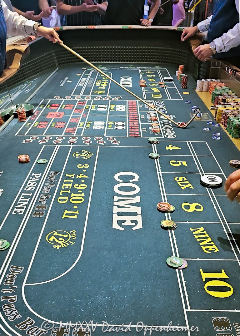 Craps table gambling at The Venetian casino in Las Vegas, Nevada - © 2025 David Oppenheimer - Performance Impressions travel photography archives - https://performanceimpressions.com The Venetian, casino, Las Vegas, craps, craps table, dice, chips, casino chips, money, roll of the dice, roll the dice, dice game, roll, table, gaming, play, Nevada, odds, win, gambling, wager, bet, luck, gamble, resort, 3355 S Las Vegas Blvd, 89109, United States, vertical, color, 1-14977862771