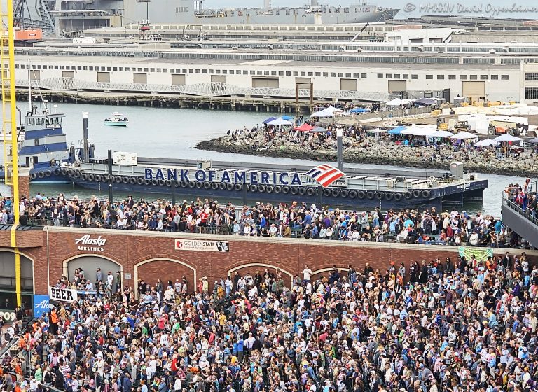 Deadheads at Dead & Company Final Tour at Oracle Park stadium with Shakedown Street at China Basin Park and Pier 48 in the background in San Francisco, California on July 16, 2023 - © 2024 David Oppenheimer - Performance Impressions photography archives - https://performanceimpressions.com Dead & Company, Dead & Company Final Tour, Final Tour, tour, Oracle Park, Grateful Dead, crowd, entrance, enter, stadium, baseball field, baseball diamond, San Francisco Bay, field, seats, bleachers, seating, hippies, San Francisco, people, fans, deadheads, packed, packed crowd, California, line, SoMA, building, architecture, baseball stadium, Willie Mays Plaza, 94107, Populous, HOK Sport, HOK Sport Venue Event, outside, O’Doul Gate, Lefty O'Doul Gate, Third Street, gate, barge, drone barge, Bank of America, Bank of America barge, Pier 48, China Basin Park, Mission Bay, San Francisco Pier 48, Shakedown, Shakedown Street, Mission Rock, concert, concert photography, David Oppenheimer, 1-13985601741,