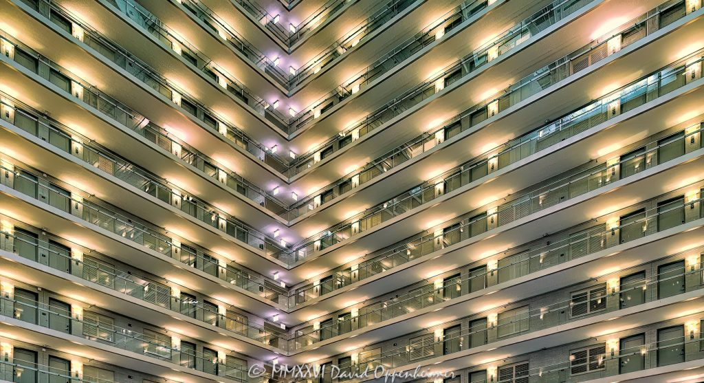 Embassy Suites by Hilton Chicago Downtown Magnificent Mile atrium interior in Streeterville, Chicago, Illinois, looking upward at angled guestroom corridors and converging walkways within the hotel’s open central atrium. Strong linear geometry, repeating railings, dramatic perspective and unusual interior lighting create an abstract architectural composition within the multi-story hotel interior – © 2026 David Oppenheimer – Performance Impressions photography archives https://performanceimpressions.com Embassy Suites by Hilton Chicago Downtown Magnificent Mile, Embassy Suites Chicago Downtown Magnificent Mile, Embassy Suites Chicago Magnificent Mile, Embassy Suites Magnificent Mile, Embassy Suites Chicago, Embassy Suites by Hilton, Embassy Suites, Chicago Embassy Suites, 511 North Columbus Drive, 511 N Columbus Drive, 511 N Columbus Dr, 60611, Embassy Suites atrium, Embassy Suites interior, hotel atrium, Chicago hotel atrium, atrium interior, Chicago hotel interior, hotel interior, abstract atrium view, abstract atrium, abstract interior, abstract architecture, architectural abstraction, geometric abstraction, architectural abstract, atrium view, looking up, upward view, angled view, interior perspective, upward perspective, dramatic perspective, converging walkways, converging lines, angled walkways, diagonal walkways, corner walkways, intersecting corridors, guestroom corridors, guest corridors, hotel corridors, atrium corridors, open corridors, gallery corridors, interior corridors, hotel hallways, interior hallways, walkways, interior walkways, open walkways, stacked corridors, stacked floors, upper floors, multiple floors, multiple levels, hotel floors, guestroom levels, guestroom doors, room doors, railings, corridor railings, open atrium, central atrium, multi-story atrium, multistory atrium, multi-level atrium, tall atrium, large atrium, vast interior, open interior, open volume, atrium architecture, interior architecture, hotel architecture, hospitality architecture, hospitality design, interior design, commercial interior, commercial architecture, horizontal lines, vertical lines, diagonal lines, repeating lines, linear architecture, linear geometry, architectural lines, architectural geometry, geometric architecture, geometric interior, geometric design, angular geometry, repeating geometry, architectural pattern, repetition, pattern, symmetry, depth, spatial depth, interior structure, building structure, structural design, structural engineering, architectural engineering, engineering, unusual lighting, interior lighting, dramatic lighting, contemporary architecture, contemporary interior, contemporary design, Art Deco, Art Deco architecture, Art Deco interior, Art Deco influence, modern Art Deco, retro, retro design, retro interior, 2000s architecture, hotel design, all-suite hotel, all suite hotel, upscale hotel, full service hotel, Chicago hotel, downtown Chicago hotel, Magnificent Mile hotel, Streeterville hotel, Chicago hospitality, Streeterville, River East, River East Chicago, Magnificent Mile, downtown Chicago, Near North Side, Columbus Drive, Chicago, Chicago Illinois, Illinois, United States, USA, Embassy Suites Chicago Downtown-Lakefront, Embassy Suites Downtown Lakefront, Chicago Downtown Lakefront, DeStefano + Partners, DeStefano and Partners, DeStefano Partners, Greg Randall, architect, architects, architecture firm, The Gettys Group, Gettys Group, Gettys, interior designer, MCL Companies, MCL, developer, Hilton, Hilton Hotels, Hilton Worldwide, Hilton Worldwide Holdings, HLT, NYSE HLT, Hilton stock, Host Hotels & Resorts, Host Hotels, Host Hotels and Resorts, HST, NASDAQ HST, hotel REIT, hospitality, hotel, atrium, interior, architecture, structure, geometry, geometric, corridors, hallway, walkways, railings, lighting, architectural photography, interior photography, hotel photography, atrium photography, abstract photography, geometric photography, Chicago architecture photography, structural photography, fine art photography, architectural print, photographic print, archival print, gallery print, collector print, wall art, Chicago architecture art, hotel art, atrium art, abstract art, geometric art, licensing, image licensing, commercial imagery, photography licensing, art, print, fine art, commercial photography, David Oppenheimer, David Oppenheimer photography, Performance Impressions, Performance Impressions photography archives, horizontal, 1-15213827141