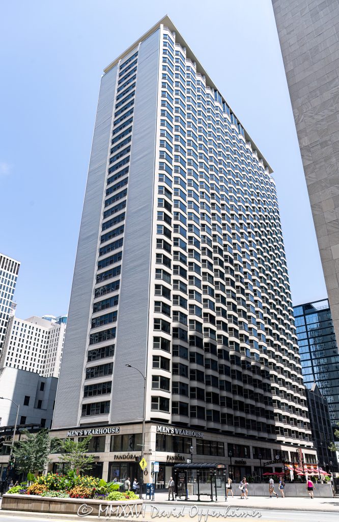 Five Thirty Five North Michigan Avenue at 535 North Michigan Avenue in Chicago, Illinois, shown in a vertical exterior view of the mixed-use condominium high-rise on the Magnificent Mile. The street-level retail frontage includes Men’s Wearhouse and Pandora storefronts along North Michigan Avenue in the Streeterville neighborhood – © 2026 David Oppenheimer – Performance Impressions photography archives https://performanceimpressions.com Five Thirty Five North Michigan Avenue, Five Thirty Five, 535 North Michigan Avenue, 535 N Michigan Avenue, 535 N Michigan Ave, The Private Residences, 535 N Michigan, North Michigan Avenue, Michigan Avenue, Magnificent Mile, Mag Mile, Streeterville, Streeterville Chicago, Near North Side, downtown Chicago, Chicago, Chicago Illinois, Chicago IL, Illinois, 60611, facade, building exterior, exterior, tower exterior, retail frontage, storefront, storefronts, street level retail, retail facade, commercial frontage, mixed-use building, condominium building, condo tower, residential tower, high-rise, high rise, tower, building, urban building, Chicago tower, Chicago high rise, city views, Michigan Avenue retail, Magnificent Mile retail, retail, shopping, luxury shopping, urban retail, Chicago shopping, Men’s Wearhouse, Mens Wearhouse, Men’s Wearhouse Chicago, Tailored Brands, suits, menswear, formalwear, tuxedos, alterations, Pandora, Pandora Jewelry, Pandora Chicago, Pandora Magnificent Mile, Pandora A/S, jewelry store, jewelry retail, charms, bracelets, rings, retail signage, store signage, signs, sign, architecture, architectural photography, Chicago architecture, commercial architecture, residential architecture, high-rise architecture, Richard Raggi & Associates, Community Specialists, real estate, Chicago real estate, Streeterville real estate, Magnificent Mile real estate, residential real estate, condo real estate, retail real estate, commercial real estate, tourism, travel, destination, United States, licensing, image licensing, commercial imagery, photography licensing, art, print, fine art, commercial photography, David Oppenheimer, vertical, 1-15213827141