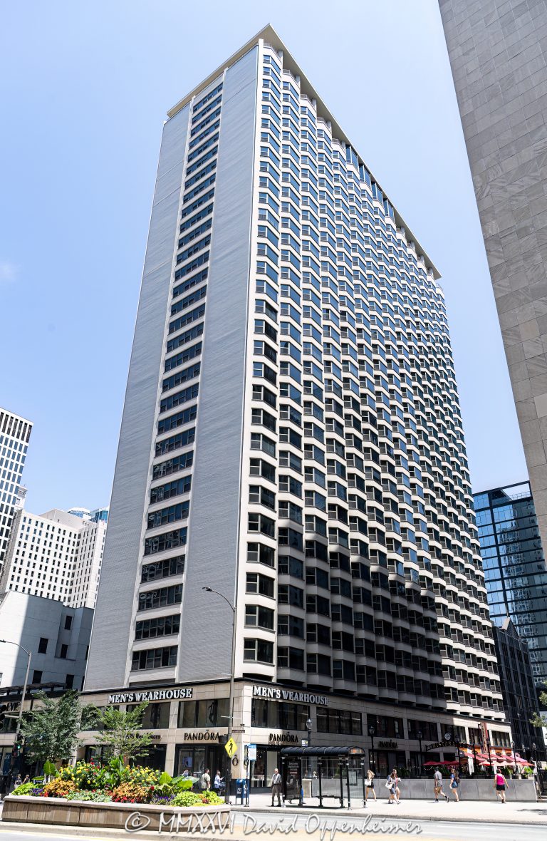 Five Thirty Five North Michigan Avenue at 535 North Michigan Avenue in Chicago, Illinois, shown in a vertical exterior view of the mixed-use condominium high-rise on the Magnificent Mile. The street-level retail frontage includes Men’s Wearhouse and Pandora storefronts along North Michigan Avenue in the Streeterville neighborhood – © 2026 David Oppenheimer – Performance Impressions photography archives https://performanceimpressions.com Five Thirty Five North Michigan Avenue, Five Thirty Five, 535 North Michigan Avenue, 535 N Michigan Avenue, 535 N Michigan Ave, The Private Residences, 535 N Michigan, North Michigan Avenue, Michigan Avenue, Magnificent Mile, Mag Mile, Streeterville, Streeterville Chicago, Near North Side, downtown Chicago, Chicago, Chicago Illinois, Chicago IL, Illinois, 60611, facade, building exterior, exterior, tower exterior, retail frontage, storefront, storefronts, street level retail, retail facade, commercial frontage, mixed-use building, condominium building, condo tower, residential tower, high-rise, high rise, tower, building, urban building, Chicago tower, Chicago high rise, city views, Michigan Avenue retail, Magnificent Mile retail, retail, shopping, luxury shopping, urban retail, Chicago shopping, Men’s Wearhouse, Mens Wearhouse, Men’s Wearhouse Chicago, Tailored Brands, suits, menswear, formalwear, tuxedos, alterations, Pandora, Pandora Jewelry, Pandora Chicago, Pandora Magnificent Mile, Pandora A/S, jewelry store, jewelry retail, charms, bracelets, rings, retail signage, store signage, signs, sign, architecture, architectural photography, Chicago architecture, commercial architecture, residential architecture, high-rise architecture, Richard Raggi & Associates, Community Specialists, real estate, Chicago real estate, Streeterville real estate, Magnificent Mile real estate, residential real estate, condo real estate, retail real estate, commercial real estate, tourism, travel, destination, United States, licensing, image licensing, commercial imagery, photography licensing, art, print, fine art, commercial photography, David Oppenheimer, vertical, 1-15213827141