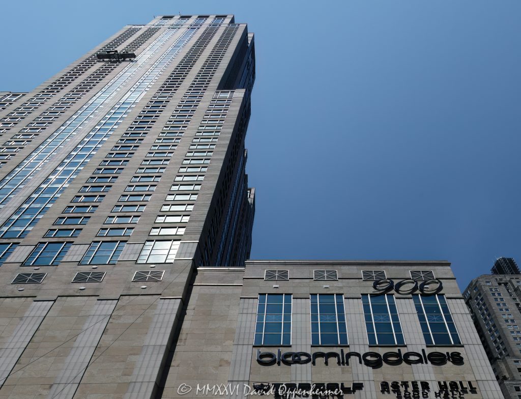 Four Seasons Hotel Chicago and Bloomingdale’s at 900 North Michigan Avenue in Chicago, Illinois, shown in a horizontal daytime exterior view of the mixed-use tower and retail base on the Magnificent Mile. The 900 North Michigan Shops frontage includes visible Aster Hall and Topgolf Swing Suite signage beneath the hotel, office, retail, and residential high-rise designed by Kohn Pedersen Fox with Perkins & Will – © 2026 David Oppenheimer – Performance Impressions photography archives https://performanceimpressions.com Four Seasons Hotel Chicago, Bloomingdale’s, Bloomingdale’s Chicago, 900 North Michigan, 900 North Michigan Avenue, 900 N Michigan Avenue, 900 N Michigan, 900 North Michigan Shops, 900 Shops, 900 North Michigan Building, Bloomingdale’s Building, Four Seasons, Four Seasons Hotels and Resorts, Macy’s Inc, Aster Hall, Aster Hall Chicago, Topgolf Swing Suite, Topgolf, Topgolf Swing Suite 900, North Michigan Avenue, Michigan Avenue, Magnificent Mile, Mag Mile, Gold Coast, Gold Coast Chicago, Near North Side, Streeterville, downtown Chicago, Chicago, Chicago Illinois, Chicago IL, Illinois, 60611, facade, building exterior, exterior, tower exterior, hotel exterior, retail facade, storefront, retail frontage, street level retail, mixed-use tower, mixed-use building, hotel tower, luxury hotel, luxury tower, shopping center, shopping mall, retail tower, office tower, residential tower, condominium tower, condo tower, high rise, skyscraper, tower, building, limestone facade, green glass, glass facade, vertical bays, setbacks, lantern crown, postmodern architecture, luxury shopping, Chicago shopping, retail, shopping, department store, food hall, sports simulator, golf simulator, luxury retail, hotel, hospitality, travel, tourism, destination, business travel, architecture, architectural photography, Chicago architecture, commercial architecture, retail architecture, hotel architecture, high-rise architecture, real estate, Chicago real estate, Magnificent Mile real estate, hotel real estate, retail real estate, commercial real estate, residential real estate, window washing, window washers, window washing platform, building maintenance unit, suspended scaffold, facade maintenance, daytime, daylight, Kohn Pedersen Fox, KPF, Perkins & Will, Perkins+Will, Urban Investment & Development Company, Urban Retail Properties, J.A. Jones Construction, Four Seasons Hotel, 132 East Delaware Residences, Equinox, Gucci, MaxMara, Sur La Table, Aritzia, Rush Street, East Delaware Place, 120 East Delaware Place, United States, licensing, image licensing, commercial imagery, photography licensing, art, print, fine art, commercial photography, David Oppenheimer, horizontal, 1-15213827141