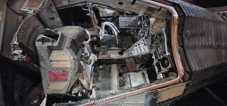 Gemini 12 spacecraft capsule at Adler Planetarium in Chicago, Illinois, displayed in the Mission Moon exhibition and viewed from above into the historic spacecraft’s crew compartment. The interior shows the seat, instrument and control panels, dials, switches, straps, hoses and flight-director attitude indicator used in the two-person Gemini spacecraft flown by astronauts Jim Lovell and Buzz Aldrin on NASA’s final crewed Gemini mission in 1966 – © 2026 David Oppenheimer – Performance Impressions photography archives https://performanceimpressions.com Gemini 12, Gemini XII, Gemini 12 capsule, Gemini XII capsule, Gemini 12 spacecraft, Gemini XII spacecraft, Gemini spacecraft, Gemini capsule, spacecraft capsule, Adler Planetarium, Adler, Adler Chicago, Adler Planetarium Chicago, Mission Moon, Mission Moon exhibit, Adler Mission Moon, Gemini 12 exhibit, Gemini exhibit, spacecraft exhibit, capsule interior, spacecraft interior, Gemini interior, crew compartment, crew station, spacecraft cockpit, cockpit, cabin, spacecraft, capsule, space capsule, historic spacecraft, flown spacecraft, NASA, NASA Gemini, NASA Gemini 12, Project Gemini, Gemini program, Gemini mission, Gemini XII mission, human spaceflight, crewed spaceflight, spaceflight, space flight, space program, space exploration, space history, space race, astronaut, astronauts, Jim Lovell, James Lovell, James A Lovell Jr, Lovell, Buzz Aldrin, Edwin Aldrin, Edwin E Aldrin Jr, Aldrin, instrument panel, control panel, controls, flight controls, instruments, instrumentation, dials, gauges, switches, knobs, flight director, attitude indicator, attitude display, flight-director attitude indicator, eight ball, eight-ball, eight-ball display, attitude control, guidance, navigation, spacecraft navigation, seat, ejection seat, straps, harness, restraints, hoses, life support, spacecraft systems, hatch, spacecraft hatch, window, reentry, reentry capsule, reentry module, reentry control, recovery section, recovery, parachute, parachute system, landing system, splashdown, rendezvous, docking, space rendezvous, Agena, Agena target vehicle, EVA, spacewalk, extravehicular activity, orbital flight, Earth orbit, 1966, November 1966, Apollo, Apollo program, lunar program, lunar missions, Moon, moonshot, Moon mission, lunar exploration, McDonnell Aircraft, McDonnell Aircraft Corp, McDonnell, Smithsonian, Smithsonian Institution, National Air and Space Museum, space artifact, museum artifact, museum exhibit, planetarium, museum, space museum, science museum, Chicago museum, Chicago space museum, Chicago science, Chicago astronomy, Chicago Museum Campus, Museum Campus, South Loop, Chicago, Chicago Illinois, Illinois, 1300 South DuSable Lake Shore Drive, 1300 S DuSable Lake Shore Drive, DuSable Lake Shore Drive, 60605, United States, USA, spacecraft photography, space photography, museum photography, science photography, aerospace photography, editorial photography, licensing, image licensing, commercial imagery, photography licensing, art, print, fine art, commercial photography, David Oppenheimer, Performance Impressions, Performance Impressions photography archives, horizontal, 1-15213827141