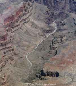 Grand Canyon aerial view of Bridge Canyon with the Colorado River winding between steep cliffs and exposed rock layers. Located within the Hualapai Indian Reservation in Mohave County, Arizona, this section of the canyon features rugged walls and deep channels that highlight the dramatic vertical scale of the terrain – © 2025 David Oppenheimer – Performance Impressions aerial photography archives – https://performanceimpressions.com Grand Canyon, Grand Canyon aerial, Grand Canyon aerial view, Grand Canyon aerial photography, Bridge Canyon, Bridge Canyon aerial, canyon, Colorado River, Hualapai Indian Reservation, canyon cliffs, canyon walls, sandstone cliffs, desert canyon, aerial desert landscape, Bridge Canyon Rapids, Pack Trail, Arizona, Arizona aerial, Grand Canyon geology, erosion, layered rock, valley, Grand Canyon National Park, canyon channel, national park, boundary, border, natural wonder, Mohave County, Mohave County aerial, Lake Mead National Recreation Area, aerial photography, aerial landscape, scenic view, vertical, 1-14993092111