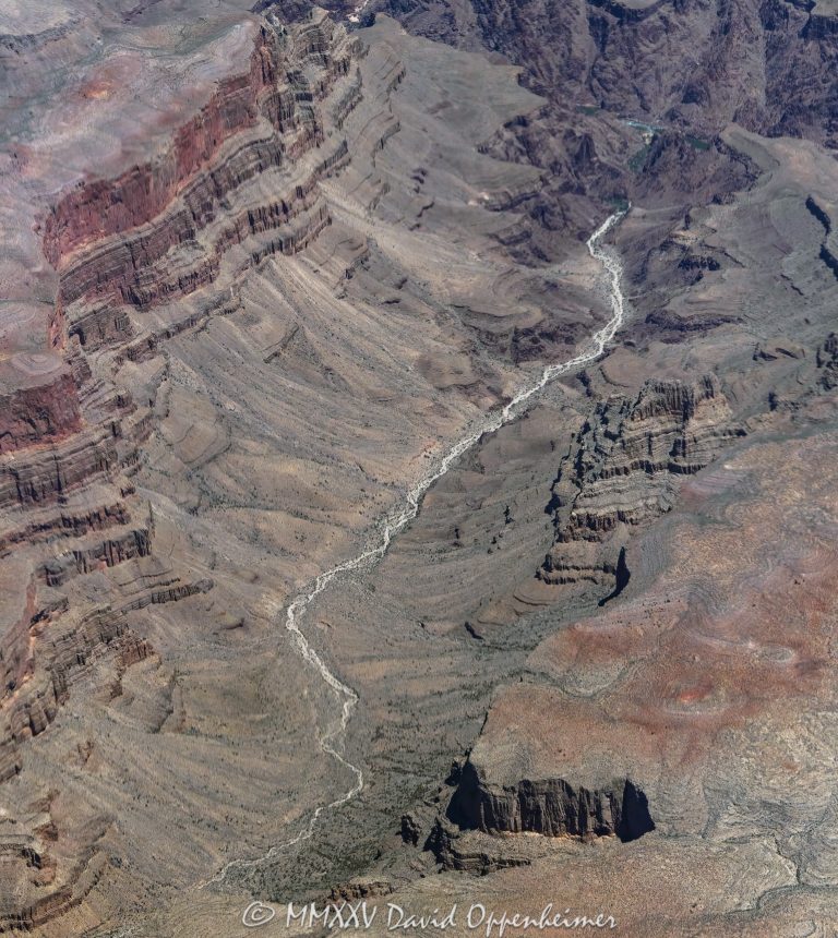 Grand Canyon aerial view of Bridge Canyon with the Colorado River winding between steep cliffs and exposed rock layers. Located within the Hualapai Indian Reservation in Mohave County, Arizona, this section of the canyon features rugged walls and deep channels that highlight the dramatic vertical scale of the terrain – © 2025 David Oppenheimer – Performance Impressions aerial photography archives – https://performanceimpressions.com Grand Canyon, Grand Canyon aerial, Grand Canyon aerial view, Grand Canyon aerial photography, Bridge Canyon, Bridge Canyon aerial, canyon, Colorado River, Hualapai Indian Reservation, canyon cliffs, canyon walls, sandstone cliffs, desert canyon, aerial desert landscape, Bridge Canyon Rapids, Pack Trail, Arizona, Arizona aerial, Grand Canyon geology, erosion, layered rock, valley, Grand Canyon National Park, canyon channel, national park, boundary, border, natural wonder, Mohave County, Mohave County aerial, Lake Mead National Recreation Area, aerial photography, aerial landscape, scenic view, vertical, 1-14993092111