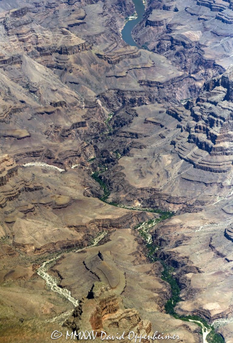 Grand Canyon aerial view of Meriwhitica Canyon in Lower Granite Gorge with the Colorado River on the Hualapai Indian Reservation in Mohave County, Arizona – © 2025 David Oppenheimer – Performance Impressions aerial photography archives – https://performanceimpressions.com Meriwhitica Canyon, Meriwhitica, Meriwhitica Springs, Indian Gardens, Spencer Springs, Lava Cliff Rapids, Spencer Canyon, Lower Granite Gorge, Lake Mead, caves, beach, riverfront, river, canyon, Colorado River, Hualapai Indian Reservation, Hualapai, rocks, granite, rocky, cliffs, canyon walls, confluence, sandstone cliffs, desert landscape, aerial, landscape, Arizona, Arizona aerial, wash, Grand Canyon geology, erosion, layered rock, valley, Grand Canyon National Park, canyon channel, national park, boundary, border, natural wonder, schist, Precambrian, plateau, Mohave County, Mohave County aerial, Lake Mead National Recreation Area, rapids, mesa, forbidden, forbidden zone, protected, habitat, ecology, trail, plateau, nature, desert, desert canyon, arid, rim, overlook, sedimentary, aerial photography, scenic view, vertical, United States, color, 1-14993092111