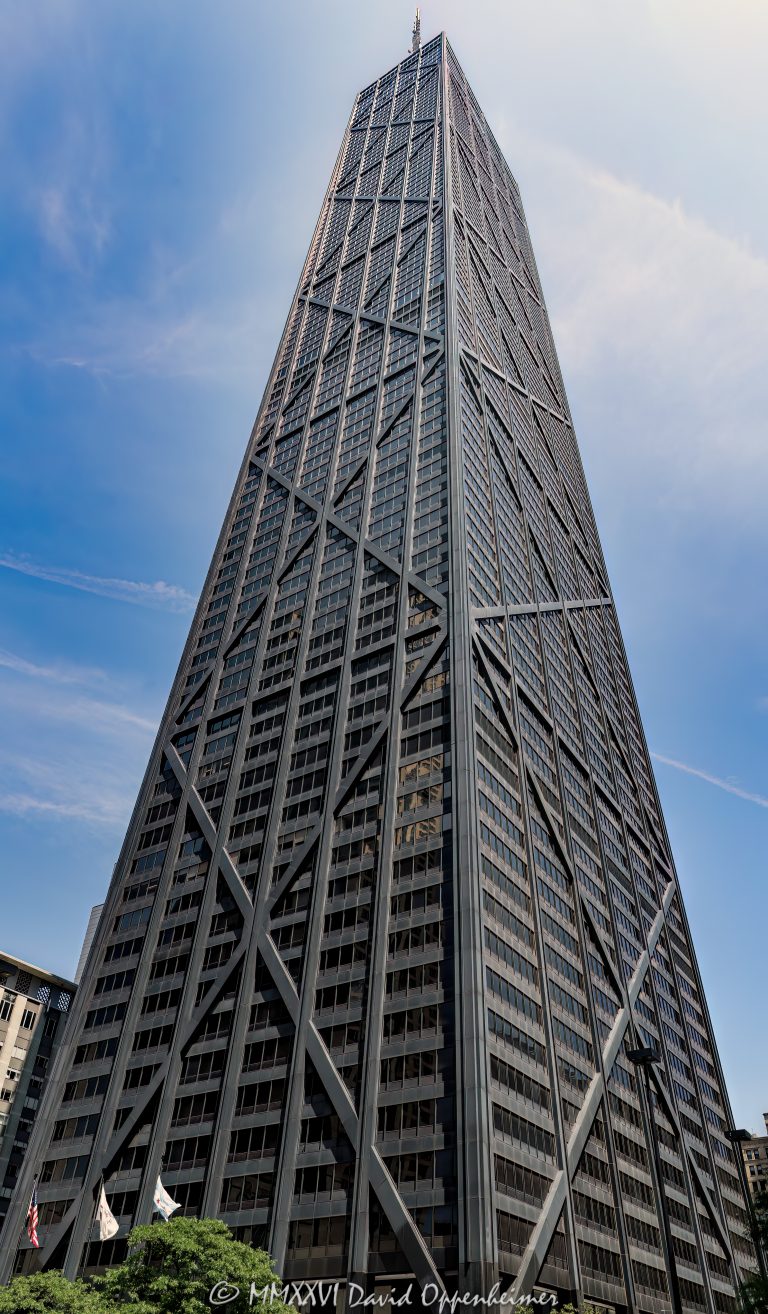875 North Michigan Avenue, formerly the John Hancock Center, rises above the Magnificent Mile in Chicago, Illinois, with a tapered black facade defined by exposed steel X-bracing. Designed by Skidmore, Owings & Merrill through the collaboration of architect Bruce Graham and structural engineer Fazlur Rahman Khan, the mixed-use tower expresses its wind-resisting diagonalized tube directly on the exterior – © 2026 David Oppenheimer – Performance Impressions photography archives https://performanceimpressions.com John Hancock Center, John Hancock Center Chicago, 875 North Michigan Avenue, 875 N Michigan Avenue, 875 N Michigan Ave, 875 North Michigan, 875 N Michigan, John Hancock Building, John Hancock Tower, former John Hancock Center, Big John, 360 Chicago, 360 Chicago Observation Deck, John Hancock Observatory, TILT, CloudBar, Signature Room, Signature Lounge, North Michigan Avenue, Michigan Avenue, Magnificent Mile, Mag Mile, East Delaware Place, East Chestnut Street, Near North Side, Streeterville, downtown Chicago, Chicago, Chicago Illinois, Chicago IL, Illinois, 60611, facade, building exterior, exterior, tower exterior, upper tower, X-bracing, X braces, cross bracing, diagonal bracing, steel bracing, bracing, exposed structure, structural frame, structural steel, steel, structure, black steel, black facade, dark facade, glass facade, curtain wall, glass, tapered facade, tapered tower, trusses, steel trusses, trussed tube, tubular structure, diagonalized tube, exterior tube, wind bracing, structural engineering, engineering, structural expressionism, architecture, architectural photography, Chicago architecture, modern architecture, modernist architecture, Modernism, midcentury modern, high-tech architecture, Magnificent Mile architecture, skyscraper, supertall, high rise, tower, building, mixed use tower, mixed use building, office tower, residential tower, condominium tower, commercial building, offices, condominiums, condos, residences, retail, observation deck, Chicago skyline, skyline views, lake views, real estate, Chicago real estate, commercial real estate, office real estate, residential real estate, condo real estate, Magnificent Mile real estate, Skidmore Owings Merrill, Skidmore Owings & Merrill, SOM, Bruce Graham, Fazlur Rahman Khan, Fazlur Khan, John Hancock Insurance, John Hancock Mutual Life Insurance Company, Tishman Construction, The Hearn Company, Illinois architecture, United States, licensing, image licensing, commercial imagery, photography licensing, art, print, fine art, commercial photography, David Oppenheimer, vertical, 1-15213827141