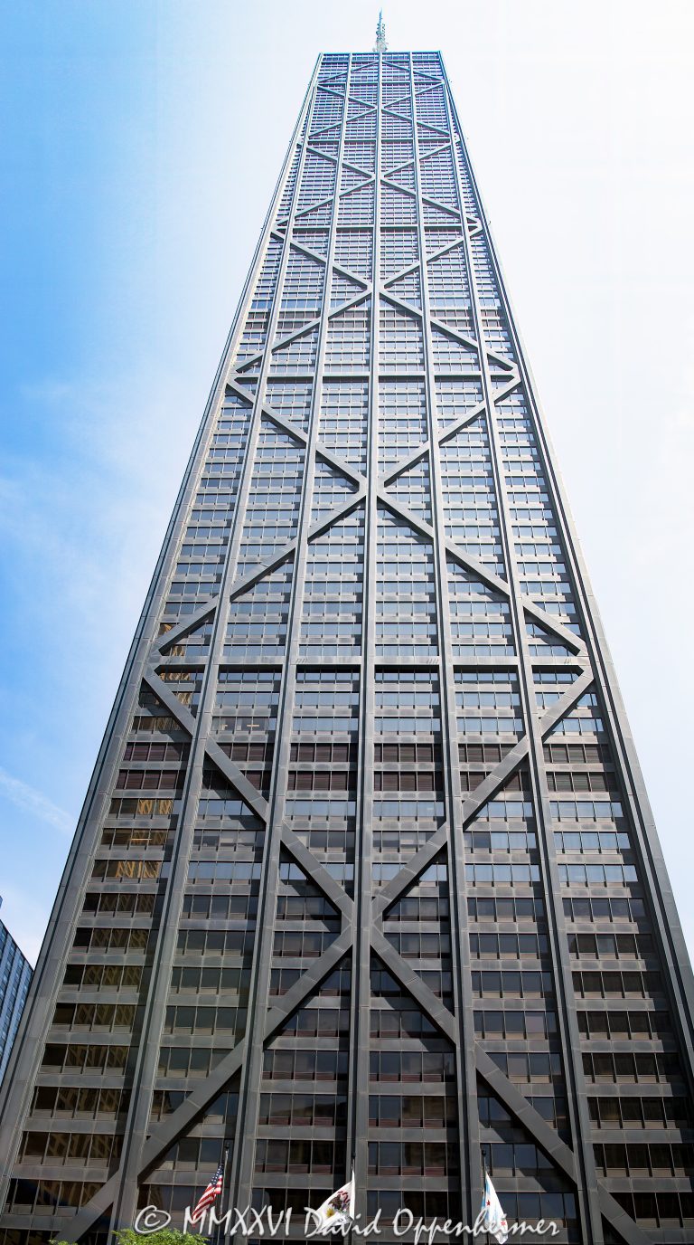 875 North Michigan Avenue, formerly the John Hancock Center, rises above the Magnificent Mile in Chicago, Illinois, with a tapered black facade defined by exposed steel X-bracing. Designed by Skidmore, Owings & Merrill through the collaboration of architect Bruce Graham and structural engineer Fazlur Rahman Khan, the mixed-use tower expresses its wind-resisting diagonalized tube directly on the exterior – © 2026 David Oppenheimer – Performance Impressions photography archives https://performanceimpressions.com John Hancock Center, John Hancock Center Chicago, 875 North Michigan Avenue, 875 N Michigan Avenue, 875 N Michigan Ave, 875 North Michigan, 875 N Michigan, John Hancock Building, John Hancock Tower, former John Hancock Center, Big John, 360 Chicago, 360 Chicago Observation Deck, John Hancock Observatory, TILT, CloudBar, Signature Room, Signature Lounge, North Michigan Avenue, Michigan Avenue, Magnificent Mile, Mag Mile, East Delaware Place, East Chestnut Street, Near North Side, Streeterville, downtown Chicago, Chicago, Chicago Illinois, Chicago IL, Illinois, 60611, facade, building exterior, exterior, tower exterior, upper tower, X-bracing, X braces, cross bracing, diagonal bracing, steel bracing, bracing, exposed structure, structural frame, structural steel, steel, structure, black steel, black facade, dark facade, glass facade, curtain wall, glass, tapered facade, tapered tower, trusses, steel trusses, trussed tube, tubular structure, diagonalized tube, exterior tube, wind bracing, structural engineering, engineering, structural expressionism, architecture, architectural photography, Chicago architecture, modern architecture, modernist architecture, Modernism, midcentury modern, high-tech architecture, Magnificent Mile architecture, skyscraper, supertall, high rise, tower, building, mixed use tower, mixed use building, office tower, residential tower, condominium tower, commercial building, offices, condominiums, condos, residences, retail, observation deck, Chicago skyline, skyline views, lake views, real estate, Chicago real estate, commercial real estate, office real estate, residential real estate, condo real estate, Magnificent Mile real estate, Skidmore Owings Merrill, Skidmore Owings & Merrill, SOM, Bruce Graham, Fazlur Rahman Khan, Fazlur Khan, John Hancock Insurance, John Hancock Mutual Life Insurance Company, Tishman Construction, The Hearn Company, Illinois architecture, United States, licensing, image licensing, commercial imagery, photography licensing, art, print, fine art, commercial photography, David Oppenheimer, vertical, 1-15213827141