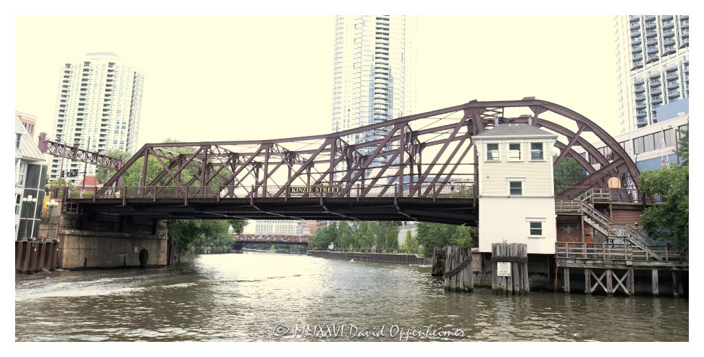 Kinzie Street Bridge crosses the North Branch of the Chicago River at Kinzie Street in downtown Chicago. Built in 1909, the single-leaf bascule highway bridge is a historic river crossing and an example of early 20th-century movable bridge engineering – © 2026 David Oppenheimer – Performance Impressions photography archives https://performanceimpressions.com Kinzie Street Bridge, Kinzie St Bridge, Chicago River Bascule Bridge Kinzie Street, Chicago River, North Branch Chicago River, Kinzie Street, downtown Chicago, Chicago, Illinois, River North, Fulton River District, Near North Side, Near West Side, Wolf Point, Cook County, 60654, 60661, bridge, bascule bridge, single leaf bascule bridge, Chicago bascule bridge, movable bridge, drawbridge, highway bridge, road bridge, truss bridge, Pratt through truss, steel bridge, river bridge, Chicago River bridge, Chicago bridges, historic bridge, historic infrastructure, bridge engineering, urban infrastructure, transportation, street bridge, bridge exterior, waterfront, riverfront, cityscape, urban landscape, Chicago architecture, Chicago engineering, Alexander von Babo, City of Chicago, John J Gallery, Historic American Engineering Record, HAER, United States, Licensing, image licensing, commercial imagery, photography licensing, art, print, fine art, commercial photography, David Oppenheimer, horizontal, 1-15156784411