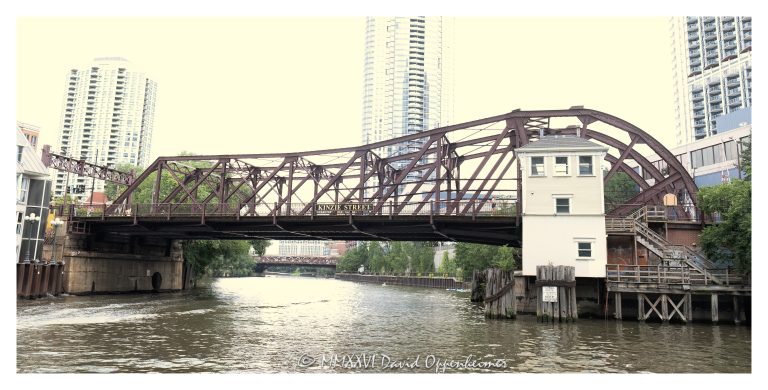 Kinzie Street Bridge crosses the North Branch of the Chicago River at Kinzie Street in downtown Chicago. Built in 1909, the single-leaf bascule highway bridge is a historic river crossing and an example of early 20th-century movable bridge engineering – © 2026 David Oppenheimer – Performance Impressions photography archives https://performanceimpressions.com Kinzie Street Bridge, Kinzie St Bridge, Chicago River Bascule Bridge Kinzie Street, Chicago River, North Branch Chicago River, Kinzie Street, downtown Chicago, Chicago, Illinois, River North, Fulton River District, Near North Side, Near West Side, Wolf Point, Cook County, 60654, 60661, bridge, bascule bridge, single leaf bascule bridge, Chicago bascule bridge, movable bridge, drawbridge, highway bridge, road bridge, truss bridge, Pratt through truss, steel bridge, river bridge, Chicago River bridge, Chicago bridges, historic bridge, historic infrastructure, bridge engineering, urban infrastructure, transportation, street bridge, bridge exterior, waterfront, riverfront, cityscape, urban landscape, Chicago architecture, Chicago engineering, Alexander von Babo, City of Chicago, John J Gallery, Historic American Engineering Record, HAER, United States, Licensing, image licensing, commercial imagery, photography licensing, art, print, fine art, commercial photography, David Oppenheimer, horizontal, 1-15156784411