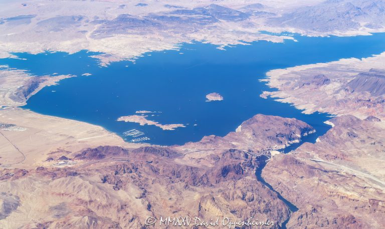 Lake Mead and Hoover Dam on the Nevada - Arizona border aerial view - © 2025 David Oppenheimer - Performance Impressions aerial photography archives - https://performanceimpressions.com Lake Mead, Lake Mead aerial, Hoover Dam, Hoover Dam aerial, Hemenway Harbor, Rock Island, Oberlink Island, Lakeview Overlook, Boulder Harbor, Boulder Beach, Moon Cove, Boxcar Cove, Hatchery Saddle Point, Kingman Wash, North Mine Road Lookout, Kingman Wash Beach, Lake Mead Marina, marina, Little Boulder Island, Big Boulder Island, Las Vegas Boat Harbor, Hemenway Harbor Launch Ramp, Horsepower Cove, Black Island, Shelter Cove, Fishfinder Cove, Battleship Rock, Swallow Bay, Lovers Cove, Callville Bay, Callville Point, Fire Bowl Cove, Callville Bay Marina, bridge, Arizona, Hoover Dam bridge, Mike O’Callaghan–Pat Tillman Memorial Bridge, Water Barge Cove, Las Vegas Bay, lake, lake aerial, desert lake, silt, sediment, Boulder City, Colorado River, Clark County, Lake Mead National Recreation Area, river, plateau, siltstone, channel fill, sinks, boating, shoreline, lakefront, delta, channel, geology, ravine, canyon, valley, valley aerial, aerial, aerial view, mountains, arid, barren, vacation, gorge, rim, red, red rocks, cliffs, bottom, lower, aerial photographer, limestone, middle, wash, erosion, rocks, erode, scenic, landscape, overlook, panoramic, wide angle, sandstone, rocky, visit, travel, American West, desert, high desert, advertising, United States, USA, America, horizontal, 1-14993092111
