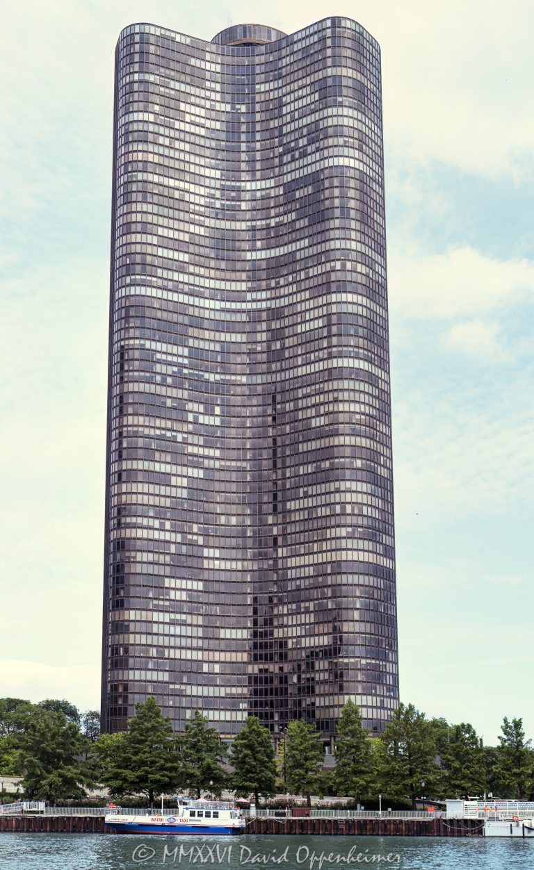 Lake Point Tower at 505 North Lake Shore Drive stands on Chicago’s Streeterville lakefront, with Ogden Slip and Shoreline Sightseeing’s Lickety Split water taxi in the foreground near the Lakefront Trail approach to Navy Pier. Designed by Schipporeit & Heinrich, the condominium tower is defined by its curving three-wing form and bronze-tinted glass curtain wall – © 2026 David Oppenheimer – Performance Impressions photography archives https://performanceimpressions.com Lake Point Tower, Lake Point Tower Chicago, Lake Point Tower Condominium, Lake Point Tower Condominiums, Lake Point Tower condos, 505 North Lake Shore Drive, 505 N Lake Shore Drive, 505 N Lake Shore Dr, North Lake Shore Drive, DuSable Lake Shore Drive, Streeterville, Streeterville Chicago, Near North Side, Navy Pier, Ogden Slip, Ogden Slip Chicago, Lickety Split, Lickety Split Water Taxi, Shoreline Water Taxi, Shoreline Sightseeing, Chicago water taxi, water taxi, docked boat, boat dock, Lakefront Trail, Chicago Lakefront Trail, Lake Michigan, Chicago lakefront, Chicago waterfront, Chicago River, Chicago, Chicago Illinois, Chicago IL, Illinois, 60611, facade, building exterior, exterior, tower exterior, curved facade, glass facade, curtain wall, bronze glass, bronze facade, bronze tinted glass, gold anodized aluminum, curved glass, Y-shaped tower, three-wing tower, condominium tower, condo tower, residential tower, residential building, condominium building, condominiums, condos, luxury condos, lakefront condos, waterfront condos, Chicago condos, Streeterville condos, high rise, skyscraper, tower, building, housing, real estate, Lake Point Tower real estate, Chicago real estate, Streeterville real estate, residential real estate, luxury real estate, lakefront real estate, waterfront real estate, lakefront living, architecture, architectural photography, Chicago architecture, residential architecture, lakefront architecture, modern architecture, modernism, International Style, Miesian architecture, midcentury modern, reinforced concrete, Schipporeit & Heinrich, Schipporeit and Heinrich, George Schipporeit, John Heinrich, Alfred Caldwell, Skyline Park, Ludwig Mies van der Rohe, boat, boats, dock, harbor, water, waterway, shoreline, lakefront, waterfront, trail, walking trail, bike trail, United States, licensing, image licensing, commercial imagery, photography licensing, art, print, fine art, commercial photography, David Oppenheimer, vertical, 1-15213827141