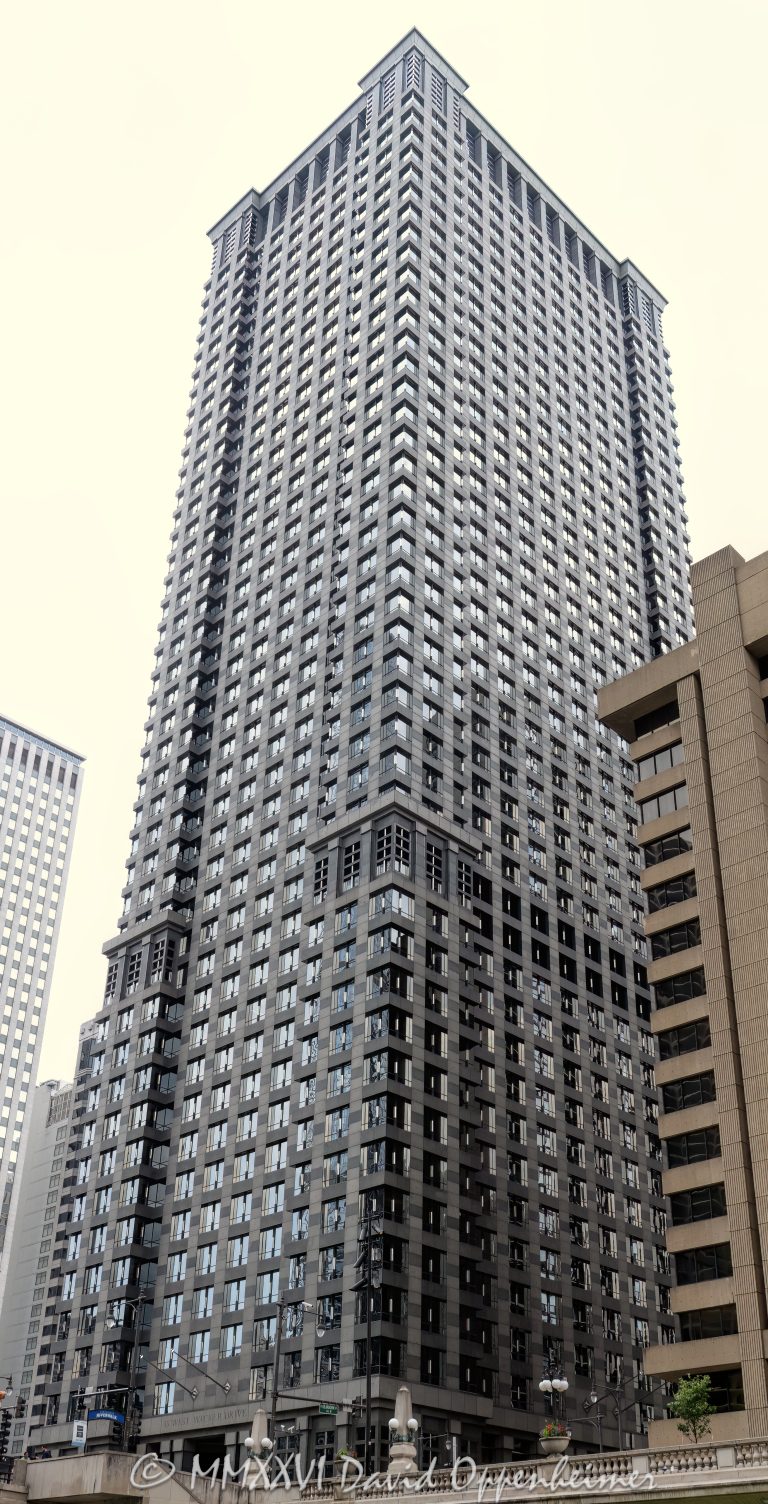 Leo Burnett Building at 35 West Wacker Drive rises above the Chicago River in the Loop, showing the postmodern office tower’s granite, glass, masonry, and stainless-steel facade. Designed by Roche Dinkeloo & Associates with Shaw & Associates and developed by The John Buck Company for Leo Burnett, the skyscraper is also widely known as 35 West Wacker – © 2026 David Oppenheimer – Performance Impressions photography archives https://performanceimpressions.com Leo Burnett Building 35 W Wacker Drive, Leo Burnett Building, 35 West Wacker, 35 West Wacker Drive, 35 W Wacker Drive, 35 W Wacker, Leo Burnett Building Chicago, 35 West Wacker Chicago, 35 W Wacker Chicago, Chicago Loop, Loop Chicago, downtown Chicago, Wacker Drive, West Wacker Drive, North Dearborn Street, Chicago River, Chicago Riverfront, Chicago Illinois, Chicago IL, 60601, facade, building exterior, exterior, tower facade, office tower, office building, commercial building, skyscraper, high rise, architecture, architectural photography, Chicago architecture, downtown Chicago architecture, corporate architecture, postmodern architecture, postmodern skyscraper, granite facade, glass facade, masonry facade, stainless steel facade, Chicago windows, Roche Dinkeloo, Roche Dinkeloo & Associates, Kevin Roche, John Dinkeloo, Kevin Roche John Dinkeloo and Associates, Shaw & Associates, The John Buck Company, Leo Burnett Worldwide, Leo Burnett Company, Leo Burnett advertising, Publicis Groupe, Publicis, advertising agency, Chicago advertising agency, corporate headquarters, Class A office building, Illinois architecture, United States, Licensing, image licensing, commercial imagery, photography licensing, art, print, fine art, commercial photography, David Oppenheimer, vertical, 1-15156784411