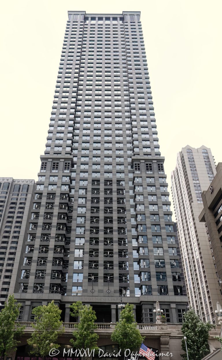 Leo Burnett Building at 35 West Wacker Drive rises above the Chicago River in the Loop, showing the postmodern office tower’s granite, glass, masonry, and stainless-steel facade. Designed by Roche Dinkeloo & Associates with Shaw & Associates and developed by The John Buck Company for Leo Burnett, the skyscraper is also widely known as 35 West Wacker – © 2026 David Oppenheimer – Performance Impressions photography archives https://performanceimpressions.com Leo Burnett Building 35 W Wacker Drive, Leo Burnett Building, 35 West Wacker, 35 West Wacker Drive, 35 W Wacker Drive, 35 W Wacker, Leo Burnett Building Chicago, 35 West Wacker Chicago, 35 W Wacker Chicago, Chicago Loop, Loop Chicago, downtown Chicago, Wacker Drive, West Wacker Drive, North Dearborn Street, Chicago River, Chicago Riverfront, Chicago Illinois, Chicago IL, 60601, facade, building exterior, exterior, tower facade, office tower, office building, commercial building, skyscraper, high rise, architecture, architectural photography, Chicago architecture, downtown Chicago architecture, corporate architecture, postmodern architecture, postmodern skyscraper, granite facade, glass facade, masonry facade, stainless steel facade, Chicago windows, Roche Dinkeloo, Roche Dinkeloo & Associates, Kevin Roche, John Dinkeloo, Kevin Roche John Dinkeloo and Associates, Shaw & Associates, The John Buck Company, Leo Burnett Worldwide, Leo Burnett Company, Leo Burnett advertising, Publicis Groupe, Publicis, advertising agency, Chicago advertising agency, corporate headquarters, Class A office building, Illinois architecture, United States, Licensing, image licensing, commercial imagery, photography licensing, art, print, fine art, commercial photography, David Oppenheimer, vertical, 1-15156784411