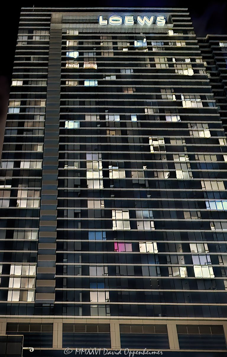 Loews Chicago Hotel and North Water Apartments tower in Streeterville, Chicago, Illinois, illuminated at night with the Loews sign above a geometric grid of lit and dark windows across the glass curtain-wall facade. The mixed-use building combines the luxury Loews hotel with the North Water residential apartments in a contemporary high-rise designed by Solomon Cordwell Buenz – © 2026 David Oppenheimer – Performance Impressions photography archives https://performanceimpressions.com Loews Chicago Hotel, Loews Chicago, Loews Hotel Chicago, Loews Chicago Downtown Hotel, Loews Hotel, Loews, 455 North Park Drive, 455 N Park Drive, 455 N Park Dr, North Water Apartments, North Water, North Water Chicago, 340 East North Water Street, 340 E North Water Street, 340 E North Water St, North Water Residences, Loews North Park Drive, Loews Hotel Tower, hotel, luxury hotel, Chicago hotel, downtown hotel, Streeterville hotel, apartments, apartment, luxury apartments, Chicago apartments, Streeterville apartments, rental apartments, residential, residential tower, residential building, multifamily, mixed-use, mixed-use tower, mixed-use building, tower, high-rise, skyscraper, building, facade, building facade, hotel facade, building exterior, exterior, architecture, Chicago architecture, hotel architecture, residential architecture, contemporary architecture, glass facade, glass tower, glass curtain wall, curtain wall, glass, windows, window grid, grid, geometric, geometry, pattern, repeating pattern, illuminated windows, lit windows, dark windows, building lights, exterior lighting, architectural lighting, night, nighttime, night architecture, Chicago night, Chicago at night, city lights, illuminated building, illuminated facade, Loews sign, hotel sign, signage, Streeterville, Streeterville Chicago, Near North Side, downtown Chicago, Chicago, Chicago Illinois, Illinois, North Park Drive, North Water Street, Chicago River, Magnificent Mile, 60611, Solomon Cordwell Buenz, SCB, architect, architects, DRW Holdings, DRW Trading Group, developer, Lendlease, general contractor, Magnusson Klemencic Associates, MKA, structural engineer, Loews Hotels & Co, Loews Hotels, Loews Corporation, NYSE L, Loews stock, hospitality, hospitality architecture, residential real estate, commercial real estate, urban architecture, urban building, United States, USA, architectural photography, architecture photography, hotel photography, night photography, nighttime photography, Chicago photography, city photography, urban photography, fine art photography, architectural print, photographic print, archival print, gallery print, collector print, wall art, Chicago art, architecture art, licensing, image licensing, commercial imagery, photography licensing, art, print, fine art, commercial photography, David Oppenheimer, Performance Impressions, Performance Impressions photography archives, vertical, 1-15213827141