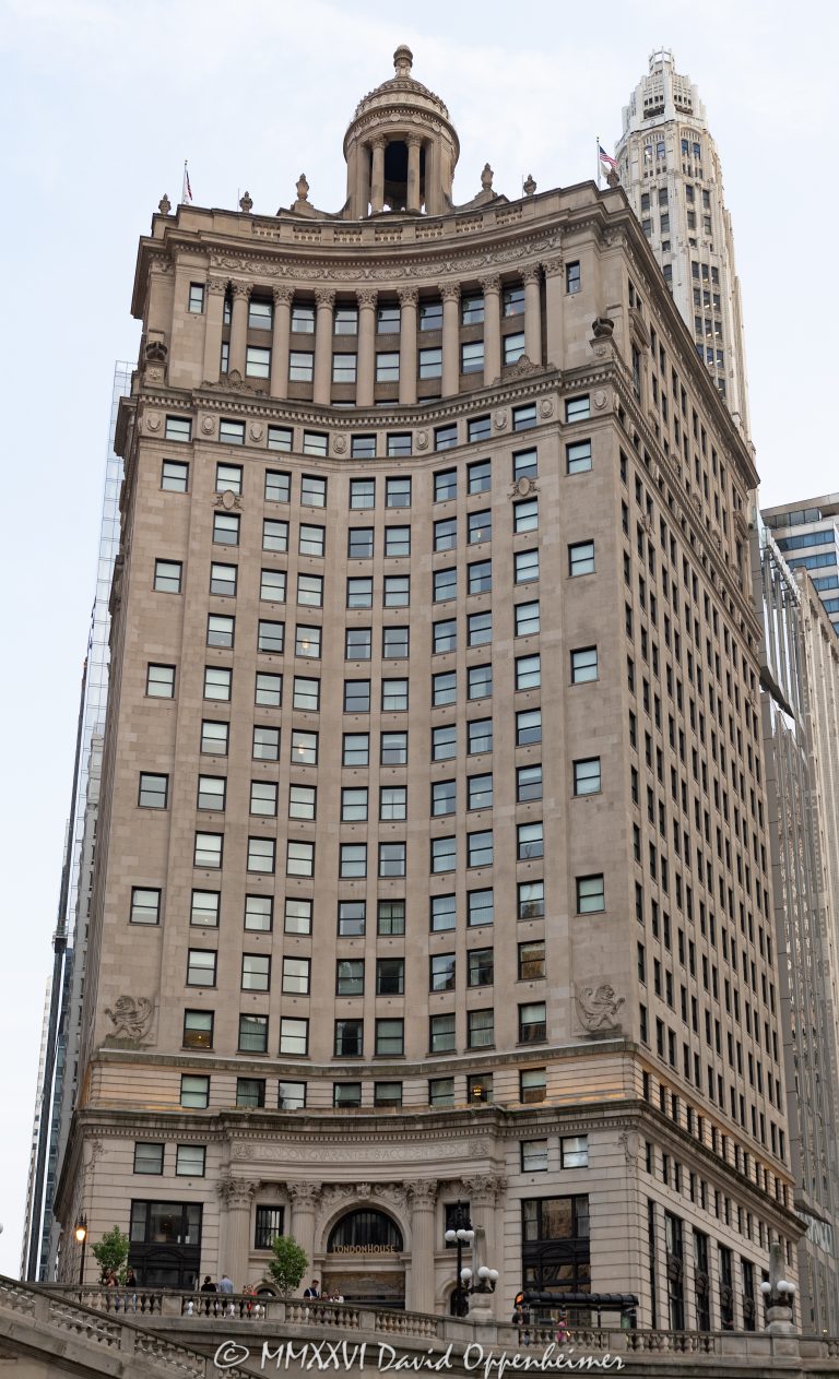 LondonHouse Chicago, Curio Collection by Hilton, at 85 East Wacker Drive occupies the restored London Guarantee Building beside the Chicago River. Alfred S. Alschuler’s Beaux-Arts tower pairs an Indiana limestone facade, Corinthian colonnades and a domed cupola with a modern glass addition by Goettsch Partners, creating a distinctive luxury hotel at Michigan Avenue and Wacker Drive in Chicago, Illinois – © 2026 David Oppenheimer – Performance Impressions photography archives https://performanceimpressions.com LondonHouse Chicago Curio Collection by Hilton, LondonHouse Chicago, LondonHouse, LondonHouse Hotel, London House Chicago, London House Hotel, Curio Collection by Hilton, Curio Collection, Hilton, Hilton Honors, Hilton Worldwide Holdings, 85 East Wacker Drive, 85 E Wacker Drive, 85 E Wacker Dr, 360 North Michigan Avenue, 360 N Michigan Avenue, 360 N Michigan Ave, London Guarantee Building, London Guarantee & Accident Building, London Guarantee and Accident Building, London Guaranty & Accident Building, Stone Container Building, Crain Communications Building, London House jazz club, London House, East Wacker Drive, Wacker Drive, North Michigan Avenue, Michigan Avenue, Chicago River, Chicago Riverwalk, Riverwalk, riverfront, waterfront, Magnificent Mile, DuSable Bridge, Michigan Avenue Bridge, Michigan Wacker Historic District, Chicago Loop, Loop Chicago, downtown Chicago, Chicago, Chicago Illinois, Chicago IL, Illinois, 60601, facade, building exterior, exterior, hotel facade, limestone facade, Indiana limestone, stone facade, Beaux-Arts, Beaux-Arts architecture, classical architecture, Corinthian columns, colonnade, cupola, domed cupola, dome, historic facade, ornate facade, glass addition, glass tower, modern addition, adaptive reuse, hotel conversion, historic hotel, luxury hotel, boutique hotel, downtown hotel, Chicago hotel, riverfront hotel, Michigan Avenue hotel, hotel, hospitality, travel, tourism, rooftop bar, LH Rooftop, LondonHouse rooftop, building, tower, high rise, skyscraper, landmark building, historic building, Chicago Landmark, Fort Dearborn, jazz history, jazz club, WLS Radio, Paul Harvey, architecture, architectural photography, Chicago architecture, hotel architecture, historic architecture, commercial architecture, Alfred S Alschuler, Alfred Alschuler, Goettsch Partners, Oxford Capital Group, Oxford Hotels & Resorts, London Guarantee and Accident Company, real estate, Chicago real estate, hotel real estate, commercial real estate, riverfront real estate, Illinois architecture, United States, licensing, image licensing, commercial imagery, photography licensing, art, print, fine art, commercial photography, David Oppenheimer, vertical, 1-15213827141