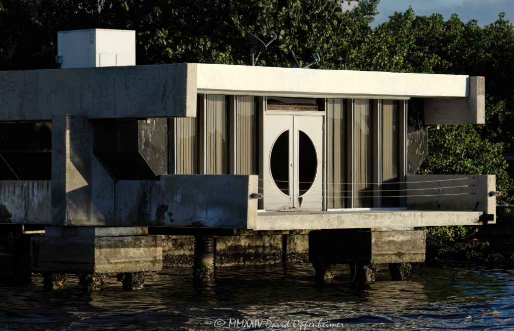 The Roman E. Moreth House Mid-century Modern signature style architectural wonder designed by William Morgan that overhangs above the New River at 3000 NE 19th St in the Dolphin Isles neighborhood in Fort Lauderdale, Florida - © 2024 David Oppenheimer - Performance Impressions photography archives - https://performanceimpressions.com Moreth House, Moreth, The Roman E. Moreth House, Roman E. Moreth House, house, Filthy Customs, Roman Moreth III, Roman Moreth, Roman E. Moreth Jr, Filthy Customs Corporation, William Morgan, New River, The Moreth House, signature style, windows, modern, tropical architecture, overhang, above, 3000 NE 19th St, design, Mid-century, Mid-century Modern, concrete, cement, deck, patio, historic, Dolphin Isles, architect, Fort Lauderdale, architecture, real estate, Fort Lauderdale real estate, estate, grounds, property, Florida, 33305, facade, waterfront, luxury real estate, dock, dockage, Intracoastal, Intracoastal Waterway, prestigious, trophy property, South Florida, Broward County, courtyard, exclusive, Art Deco, sunset, palm trees, tropical, seawall, David Oppenheimer, color, horizontal, United States, VAu 1-530-124, 1-13553735171,