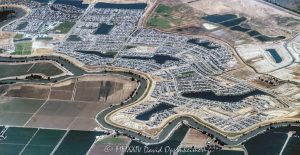 Newport at River Islands by Kiper Homes Community in Lathrop, California aerial view - © 2024 David Oppenheimer - Performance Impressions aerial photography archives - https://performanceimpressions.com Newport at River Islands, Kiper Homes, River Islands, Newport, Lathrop, community, houses, homes, 95330, real estate, properties, Cambay Group, Somerston Group, Somerston, The Cambay Group, Somerston Holdings, Bay Area, farmland, neighborhood, housing, farming, layout, plan, master plan, planned community, WHA Architects, architecture, single family homes, master-planned, San Joaquin River Delta, San Joaquin River, San Joaquin County, San Joaquin, California, Capri, Cardiff, Signature Homes, Old River, custom, spec, Chantara, The Cove, Del Webb, Driftway, Hideaway, lakes, Crystal Cove, Crystal Cove Park, Somerston Park, river, Sunny’s Lake, Paradise Lake, Lake Jefferson, Latitude Park, River Island Fields, Skye, building, new, construction, development, develop, The Shores, Waypointe, agriculture, agribusiness, aerial, aerial view, aerial photography, aerial photographer, David Oppenheimer, color, horizontal, United States, 1-13985601741,