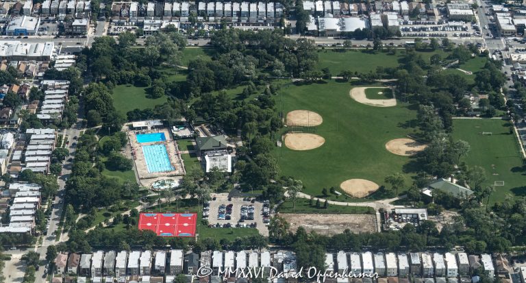 Portage Park aerial photo in Chicago’s Northwest Side neighborhood shows the summer park landscape with its outdoor pool, baseball fields, athletic fields, green lawns, and surrounding residential blocks. The Chicago Park District park at 4100 North Long Avenue is a major neighborhood recreation space in the Portage Park community area – © 2026 David Oppenheimer – Performance Impressions aerial photography archives https://performanceimpressions.com Portage Park aerial photo, Portage Park Chicago, Portage Park, Portage Park in Chicago, Portage Park Chicago park, Portage Park aerial view, Portage Park aerial, 4100 N Long Ave, 4100 North Long Avenue, Chicago Park District, Chicago park, Northwest Side Chicago, Northwest Side, Portage Park neighborhood, Portage Park community area, Chicago Illinois, Chicago IL, 60641, aerial, aerial photo, aerial photography, aerial photographer, aerial view, aerial image, summer aerial, green park, urban park, city park, neighborhood park, public park, park, recreation, outdoor recreation, outdoors, sports, athletic fields, ball fields, baseball fields, baseball diamond, baseball, soccer fields, playing fields, field, open field, green space, lawns, swimming pool, outdoor pool, public pool, pool, tennis courts, playground, fieldhouse, residential neighborhood, residential blocks, houses, homes, townhomes, townhouses, row houses, residential housing, housing, real estate, Chicago real estate, residential real estate, neighborhood real estate, urban real estate, neighborhood aerial, residential aerial, park aerial, urban planning, land use, Chicago neighborhoods, urban landscape, community recreation, public recreation, summer, green, Chicago aerial, Illinois aerial, United States, licensing, image licensing, commercial imagery, photography licensing, art, print, fine art, commercial photography, David Oppenheimer, horizontal, 1-15156784411