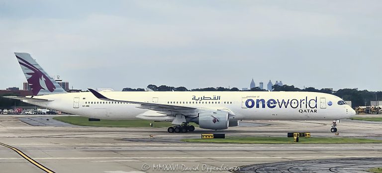 Qatar Airways Oneworld Airbus A350-1000 A7-ANE taxis at Hartsfield-Jackson Atlanta International Airport in Atlanta, Georgia. The widebody passenger jet is an Airbus A350-1041, manufacturer serial number 141, wearing the distinctive oneworld alliance livery and powered by Rolls-Royce Trent XWB-97 engines – © 2026 David Oppenheimer – Performance Impressions photography archives https://performanceimpressions.com Qatar Airways, Qatar Airways A350, Qatar Airways A350-1000, Qatar A350, Qatar A350-1000, Qatar Airways Oneworld, Qatar Oneworld, Qatar Oneworld livery, Qatar Airways Oneworld livery, Oneworld Qatar Airways, A7-ANE, A7ANE, A7 ANE, Qatar A7-ANE, Qatar Airways A7-ANE, Airbus A350-1041, A350-1041, Airbus A350-1000, A350-1000, Airbus A350, A350, Airbus A350 XWB, A350 XWB, A35K, MSN 141, serial 141, aircraft 141, oneworld, Oneworld, oneworld Alliance, airline alliance, alliance livery, oneworld livery, Oneworld aircraft, Oneworld jet, Oneworld airplane, special livery, airline livery, aircraft livery, livery, Qatar Airways livery, Qatar, State of Qatar, Qatar airline, Qatar aviation, flag carrier, national airline, airline, airlines, international airline, global airline, commercial airline, aircraft, airplane, aeroplane, plane, jet, jetliner, airliner, passenger jet, passenger aircraft, commercial aircraft, commercial aviation, civil aviation, aviation, widebody, widebody aircraft, widebody jet, wide body, twinjet, twin engine, twin engine jet, long haul, long haul aircraft, long haul jet, international aviation, Airbus, Airbus aircraft, Airbus jet, Airbus airliner, Airbus widebody, Airbus SE, aircraft manufacturer, aerospace, aerospace engineering, aircraft design, aviation engineering, Rolls-Royce, Rolls Royce, Rolls-Royce Trent, Rolls Royce Trent, Trent XWB, Trent XWB-97, XWB-97, Trent 97, Rolls-Royce engine, aircraft engine, jet engine, turbofan, turbofan engine, twin turbofan, engine, engines, taxiing, taxi, aircraft taxiing, airplane taxiing, jet taxiing, airliner taxiing, taxiway, airport taxiway, ground movement, ground operations, airport operations, aircraft operations, airline operations, airport movement, aircraft on ground, airplane on ground, jet on ground, aviation ground, ramp operations, airport ramp, airfield, airfield operations, airport, international airport, airport aviation, landing gear, aircraft landing gear, nose gear, main gear, fuselage, aircraft fuselage, wings, wing, wingtip, cockpit, aircraft cockpit, nose, aircraft nose, tail, vertical stabilizer, airline branding, aircraft branding, Hartsfield-Jackson Atlanta International Airport, Hartsfield Jackson Atlanta International Airport, Hartsfield-Jackson, Hartsfield Jackson, Atlanta International Airport, Atlanta Airport, ATL Airport, ATL, KATL, Atlanta aviation, Atlanta airport aviation, Atlanta aircraft, Atlanta airplane, Atlanta jet, Atlanta airliner, Atlanta planespotting, Atlanta plane spotting, Atlanta aircraft spotting, Atlanta, Atlanta Georgia, Georgia, Georgia aviation, Georgia airport, Georgia aircraft, 6000 North Terminal Parkway, North Terminal Parkway, 30320, City of Atlanta, Atlanta Department of Aviation, international terminal, international aviation, airport traffic, air traffic, airline traffic, aviation traffic, plane spotting, planespotting, aircraft spotting, airplane spotting, aviation spotting, spotter, aviation enthusiast, aircraft enthusiast, aviation photography, aircraft photography, airplane photography, airliner photography, airline photography, planespotting photography, airport photography, transportation photography, travel photography, editorial photography, commercial photography, fine art photography, aviation art, aircraft art, airplane art, airline art, Airbus art, A350 art, Qatar Airways art, aviation print, aircraft print, airplane print, Airbus print, A350 print, Qatar Airways print, photographic print, fine art print, archival print, gallery print, collector print, wall art, office art, licensing, image licensing, commercial imagery, photography licensing, art, print, fine art, commercial photography, David Oppenheimer, Performance Impressions, Performance Impressions photography archives, 1-15156784411