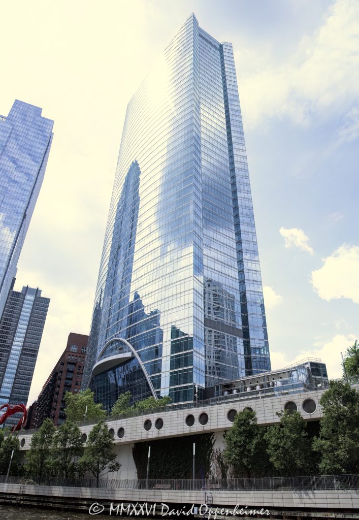 River Point at 444 West Lake Street rises along the Chicago River in the West Loop, with a curved glass office tower facade, riverboat traffic, and riverfront public space visible in the foreground. Designed by Pickard Chilton with Kendall/Heaton Associates and developed by Hines, the Class A office skyscraper includes River Point Park and Santiago Calatrava’s Constellation sculpture on the riverfront – © 2026 David Oppenheimer – Performance Impressions photography archives https://performanceimpressions.com River Point 444 West Lake Street, River Point, River Point Chicago, River Point tower, River Point office tower, 444 West Lake Street, 444 W Lake Street, 444 W Lake St, 444 West Lake, 444 W Lake, 200 North Riverside Plaza, 200 N Riverside Plaza, West Loop Chicago, West Loop, downtown Chicago, Chicago Illinois, Chicago IL, West Lake Street, Lake Street, North Canal Street, Canal Street, Chicago River, river, riverfront, waterfront, Chicago riverfront, Chicago waterfront, South Branch Chicago River, River Point Park, riverfront park, public plaza, riverside plaza, riverwalk, Riverwalk, riverboat, river boat, boats, boat, water, waterway, 60606, facade, building exterior, exterior, glass facade, curved glass, curved facade, reflective glass, office tower, office building, commercial building, Class A office, skyscraper, high rise, tower, real estate, Chicago real estate, commercial real estate, office real estate, riverfront real estate, waterfront real estate, architecture, architectural photography, Chicago architecture, riverfront architecture, contemporary architecture, commercial architecture, Pickard Chilton, Kendall Heaton, Kendall Heaton Associates, Hines, Hines Interests, Ivanhoe Cambridge, Levy Organization, Lendlease, Magnusson Klemencic, Santiago Calatrava, Constellation sculpture, public art, sculpture, urban waterfront, urban design, Chicago skyline, Illinois architecture, United States, licensing, image licensing, commercial imagery, photography licensing, art, print, fine art, commercial photography, David Oppenheimer, vertical, 1-15156784411